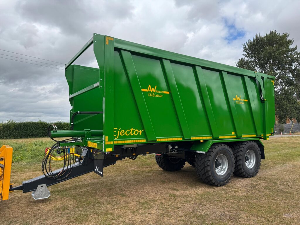 Large green trailer in field