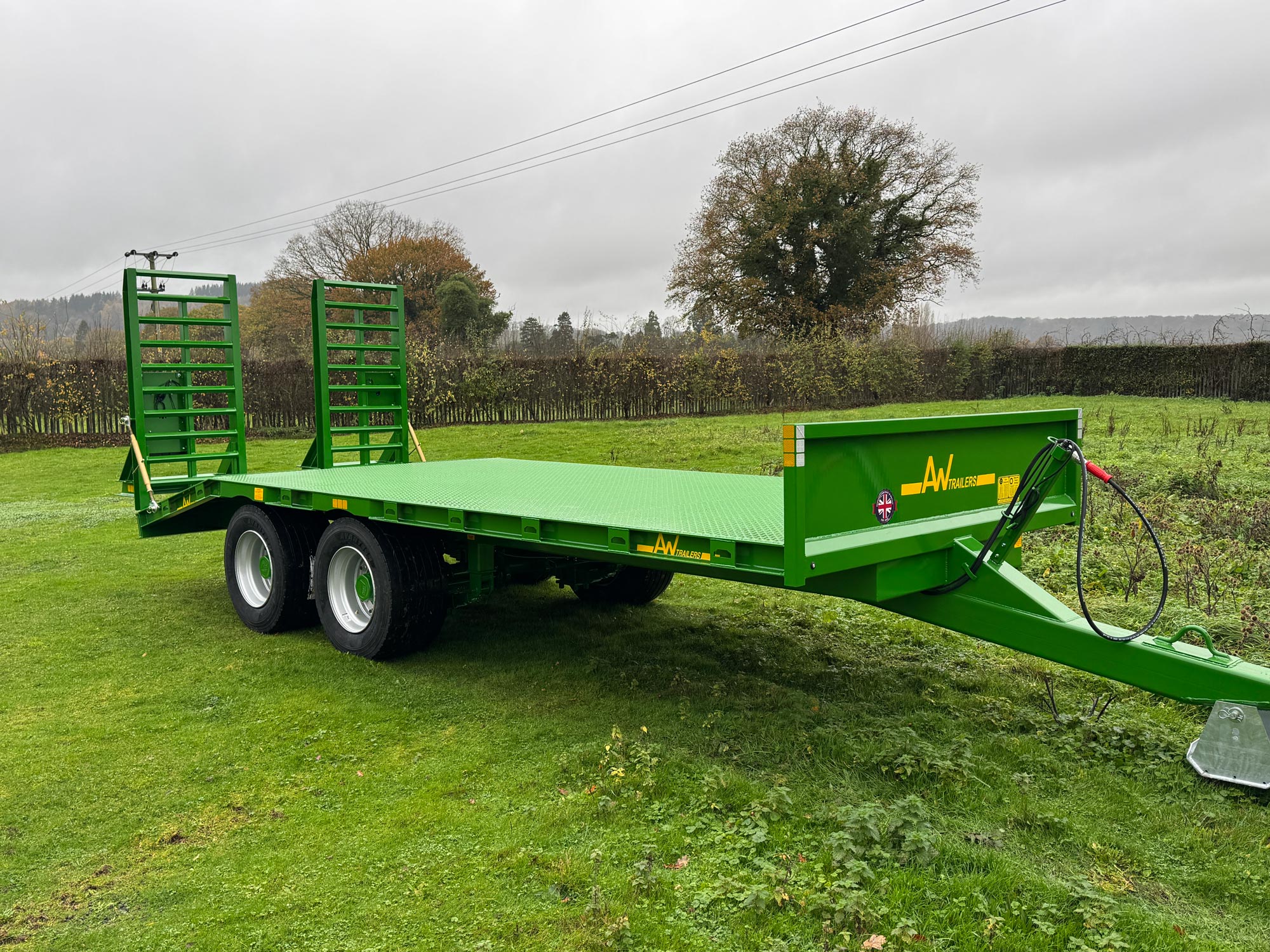A Low green trailer in a grass field