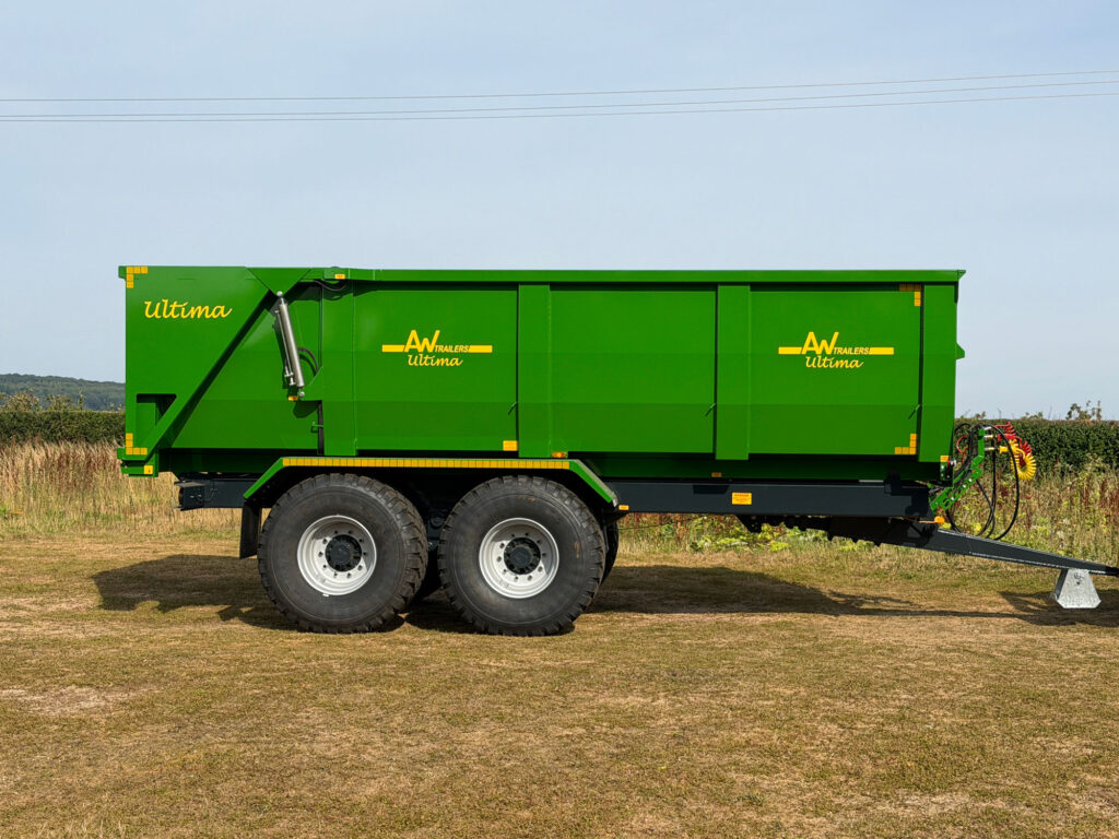 A Large green trailer in a field