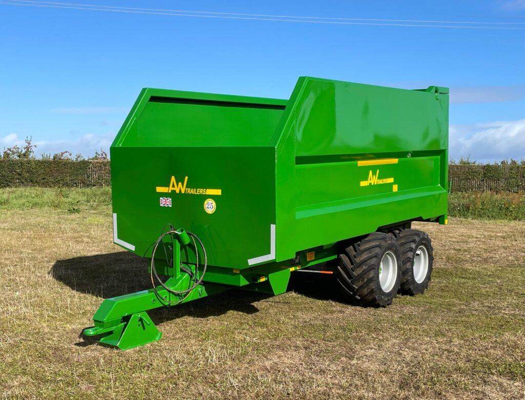 A large green trailer in a field