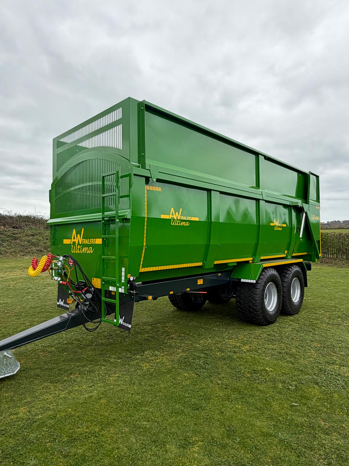A large green trailer in a field