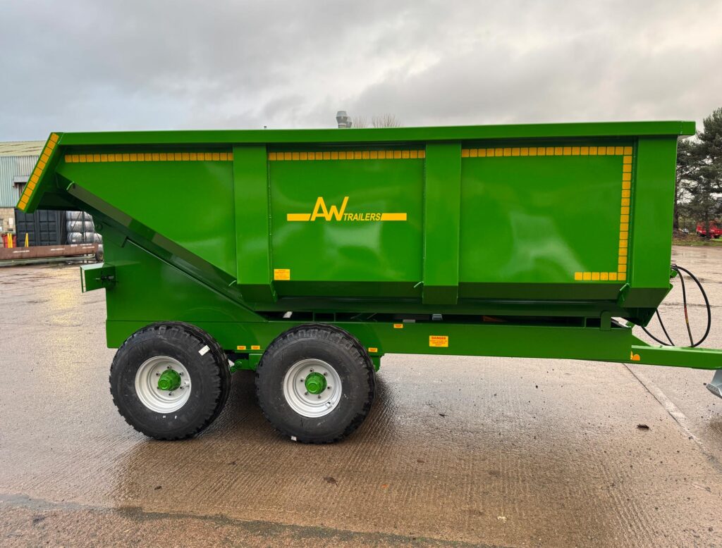 A large green trailer in a factory car park