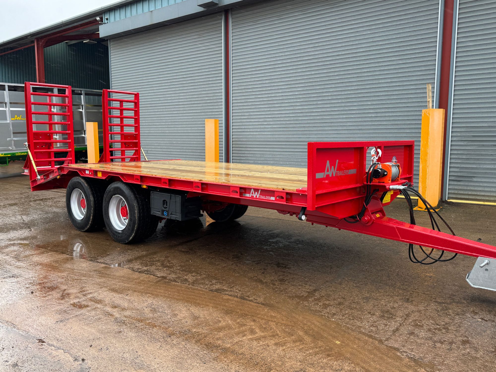 Red plant low loader trailer in a carpark