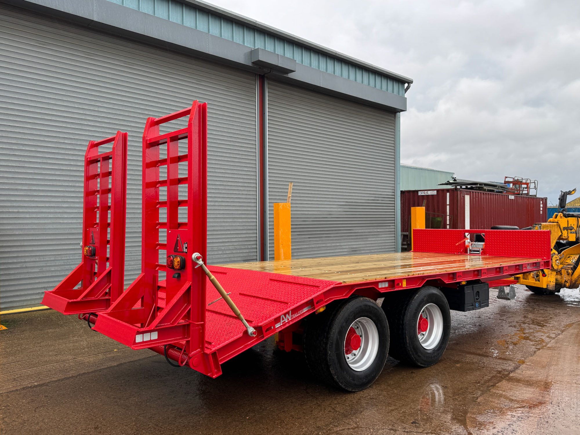 Red plant low loader trailer in a carpark
