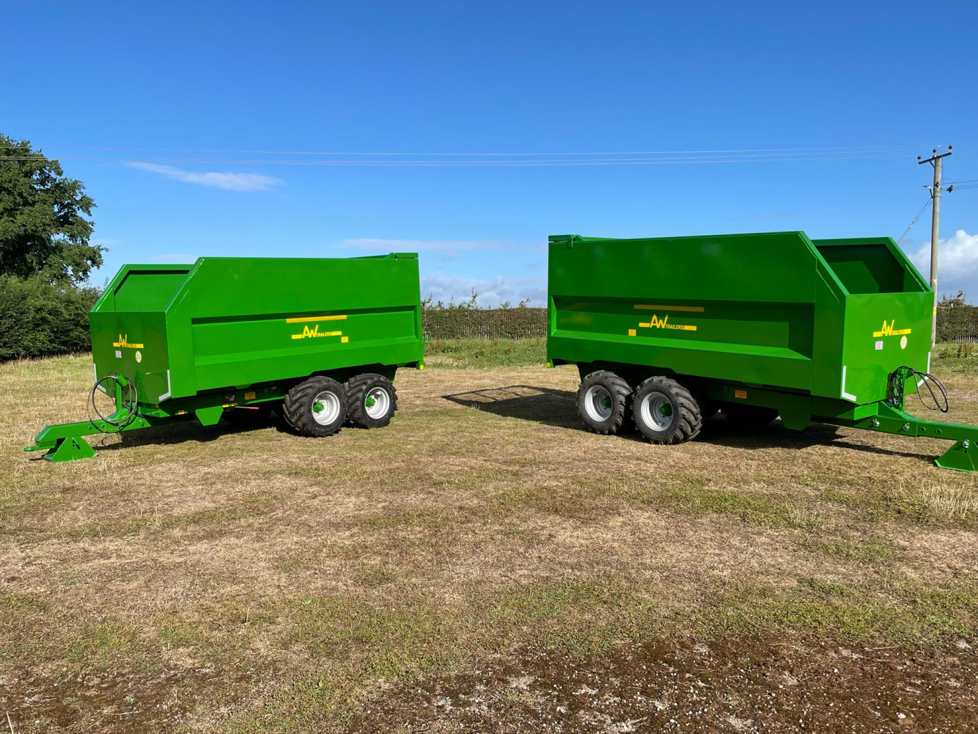 2 Large green trailers in a field