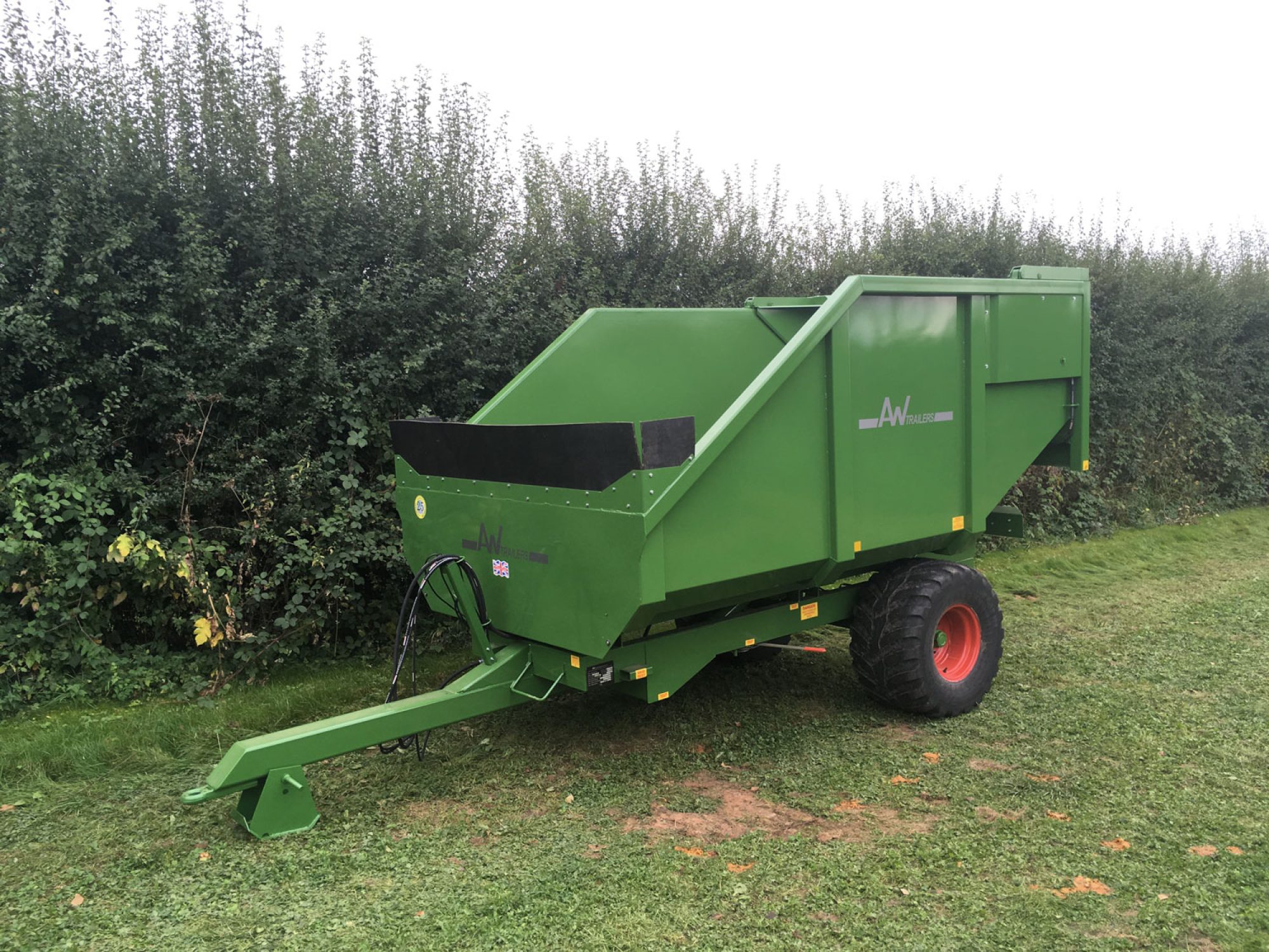 Large green trailer in a field