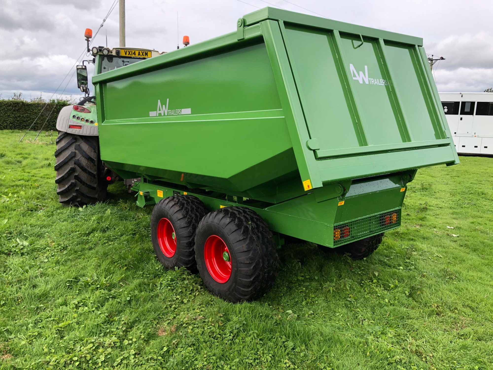 Large green trailer in a field