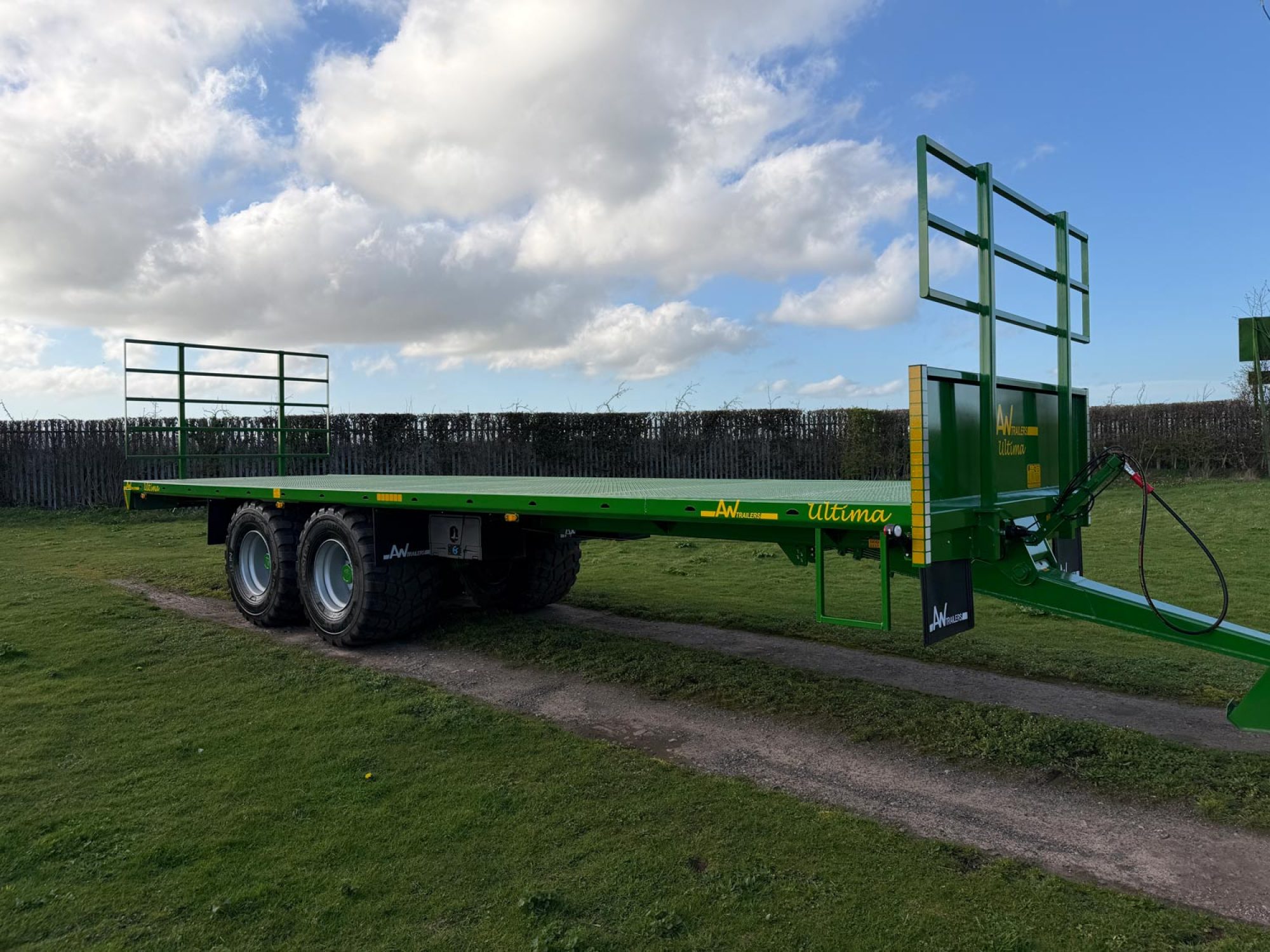 Green bale trailer in a field