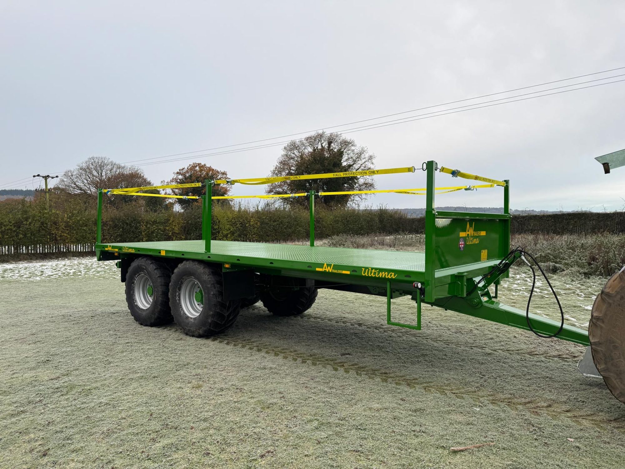 Green bale trailer in a snowy field