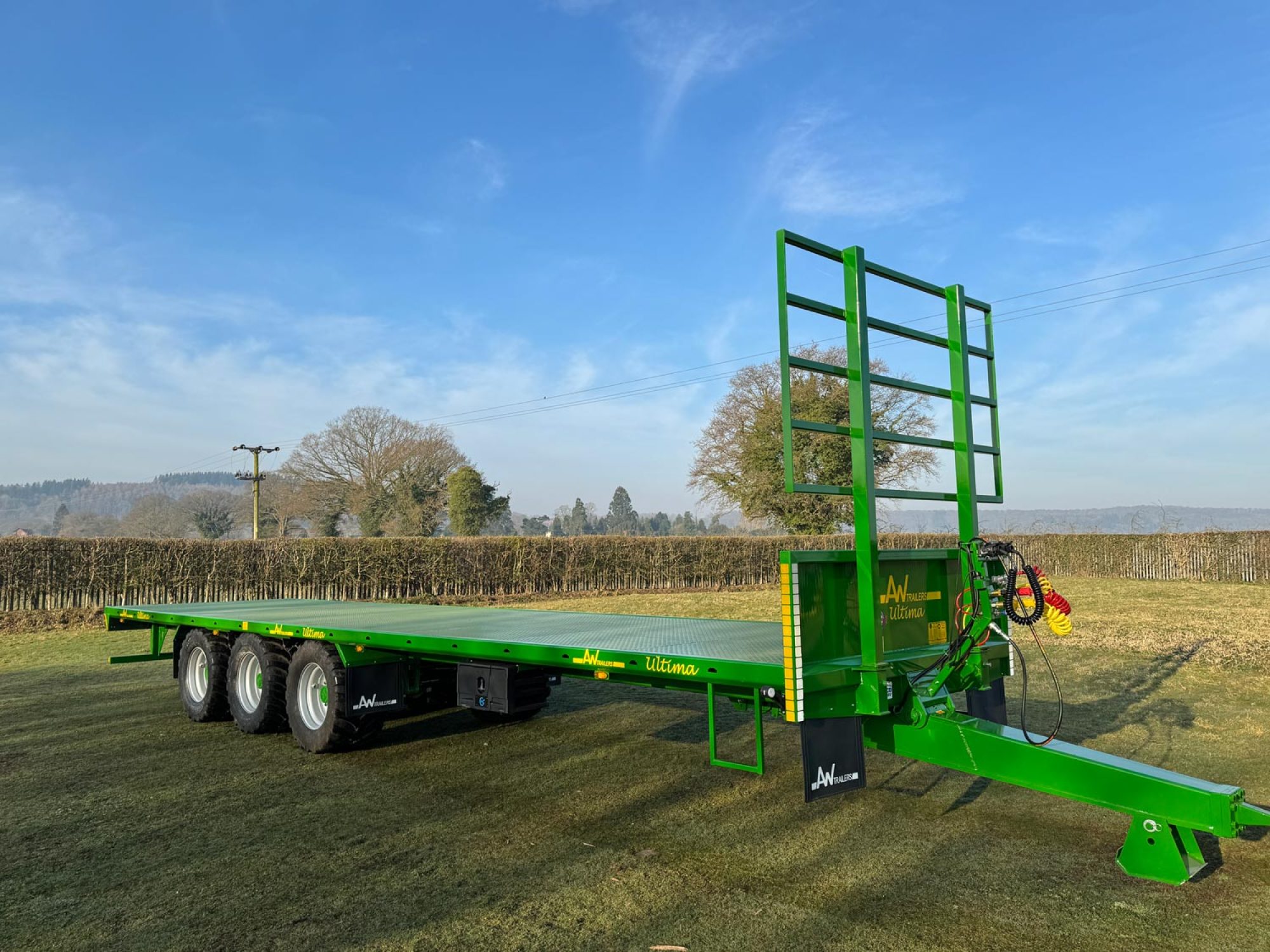 Green bale trailer in a field