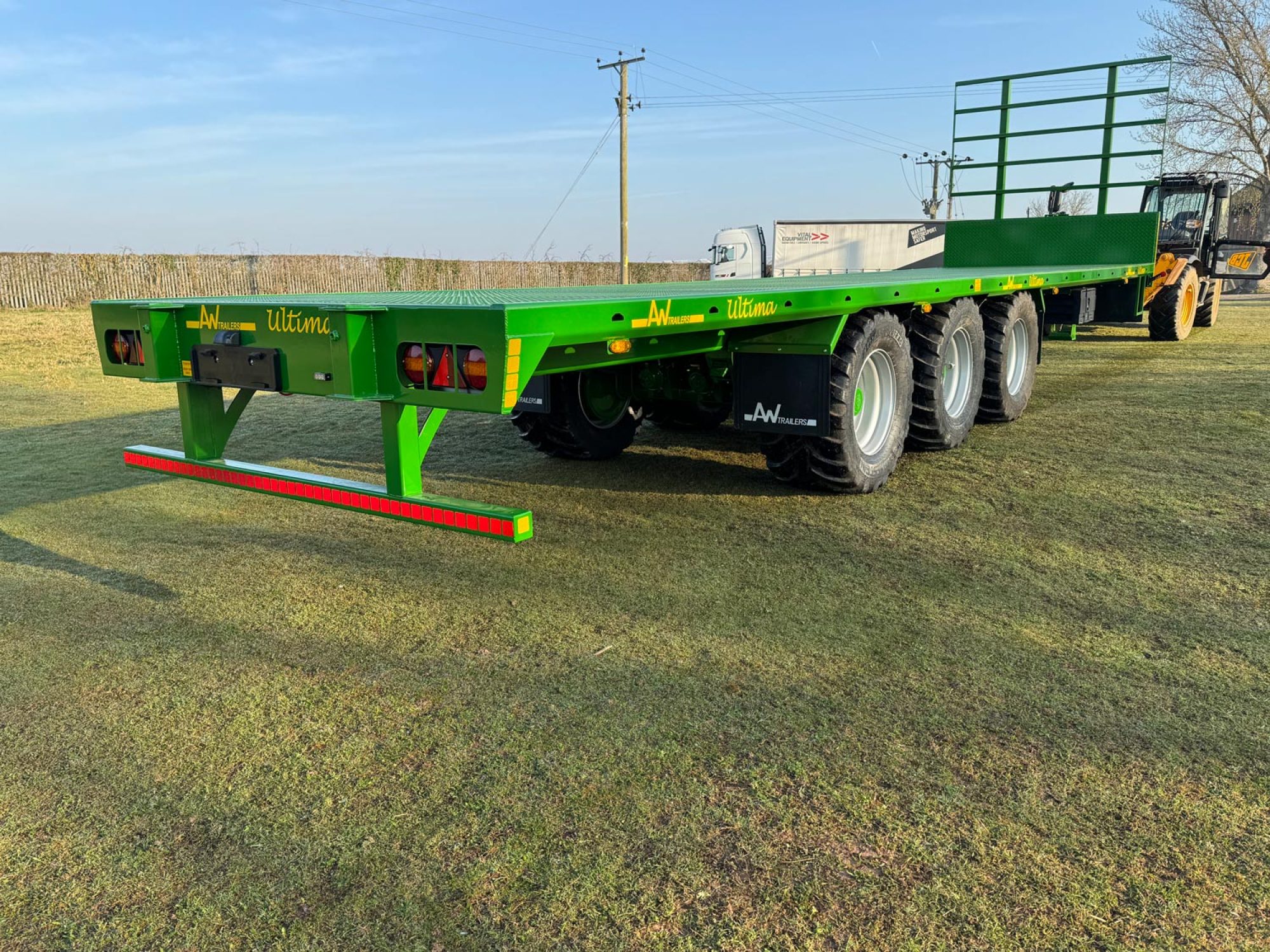 Green bale trailer in a field