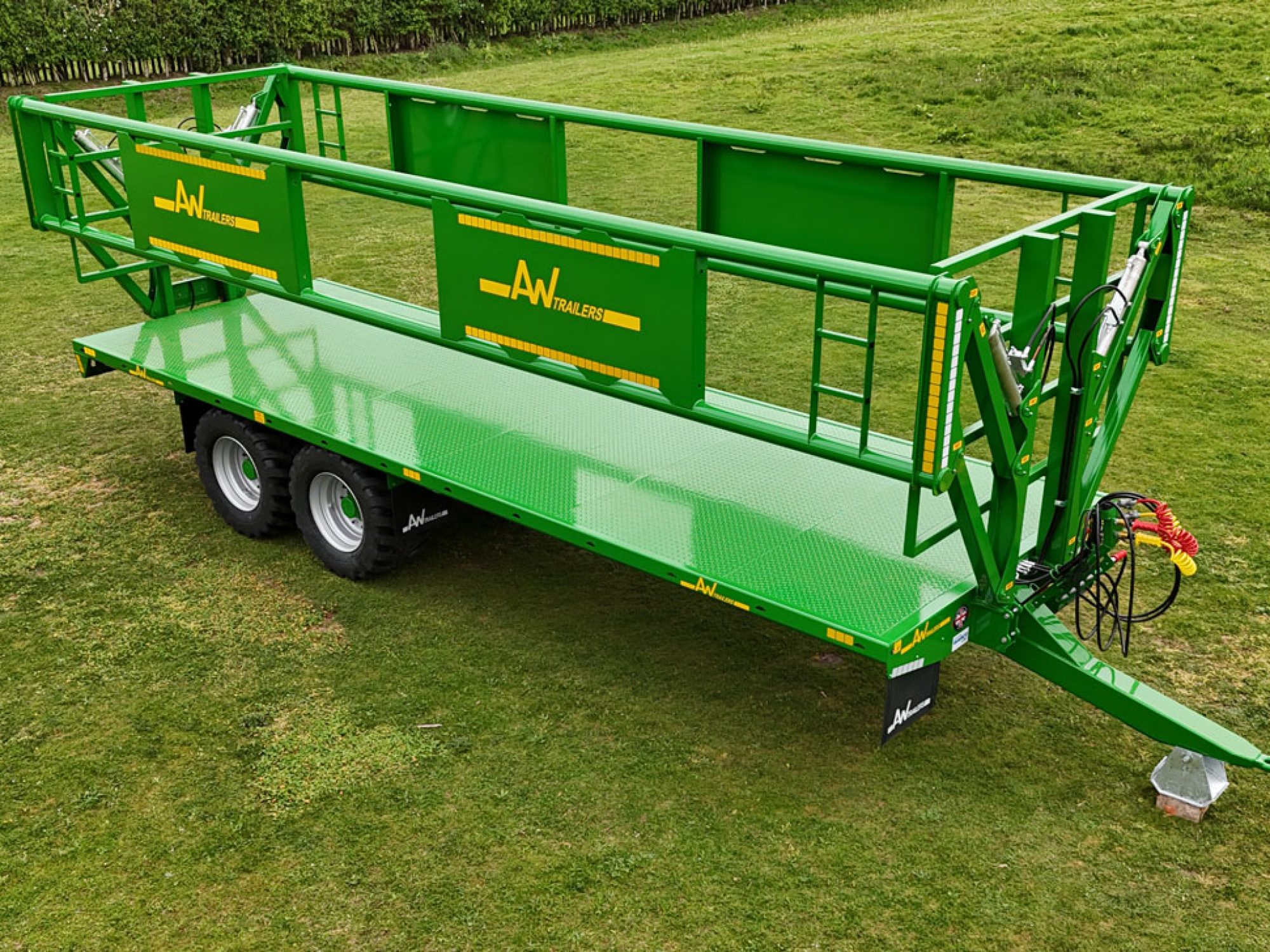 A green trailer in a grass field