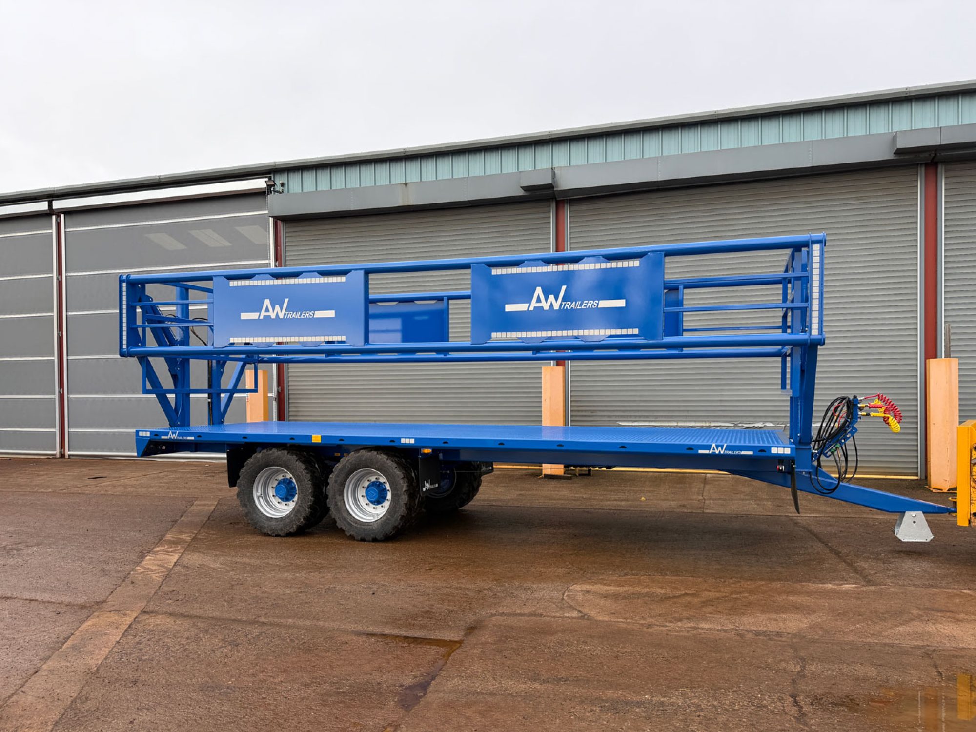 A blue trailer in a factory carpark
