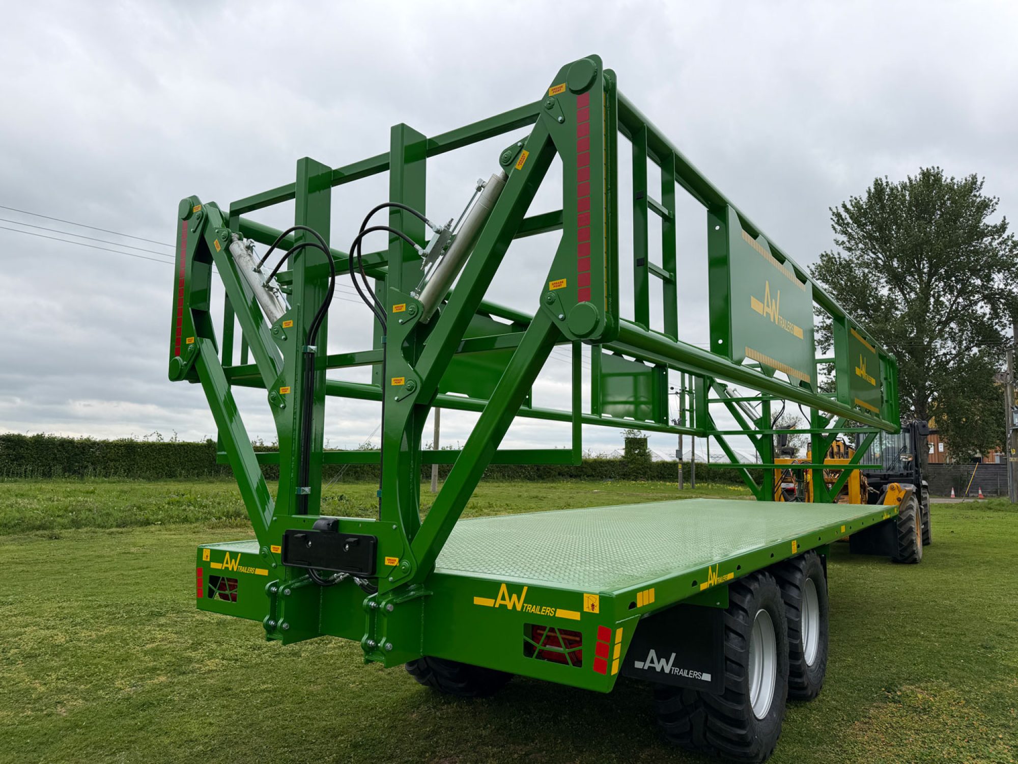 A green trailer in a field
