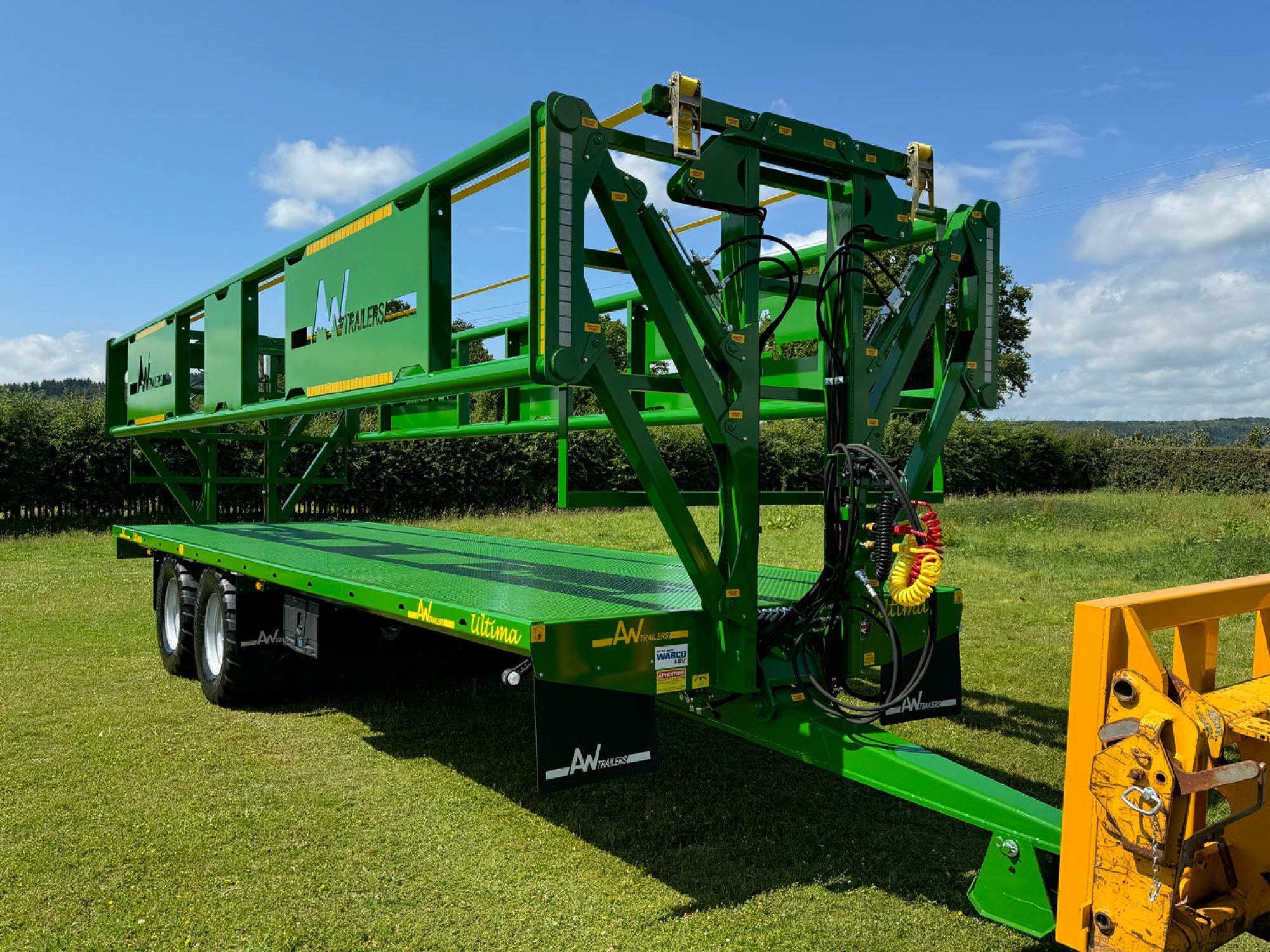 A green trailer in a field