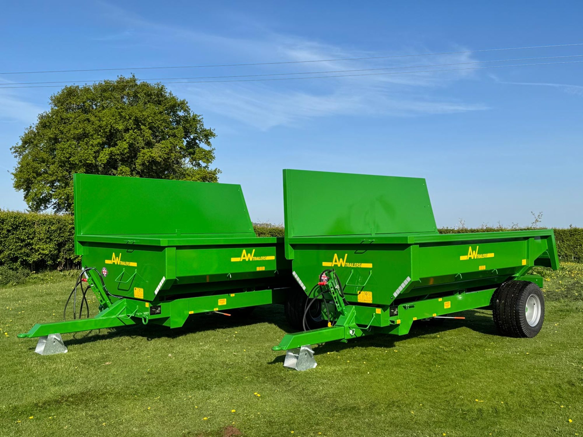 2 Large green trailers in a field