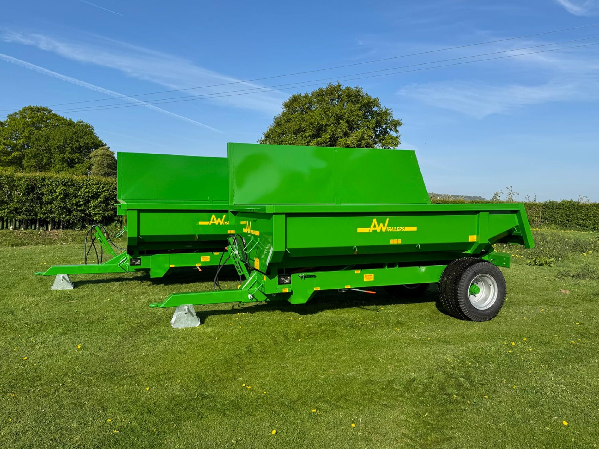 2 Large green trailers in a field