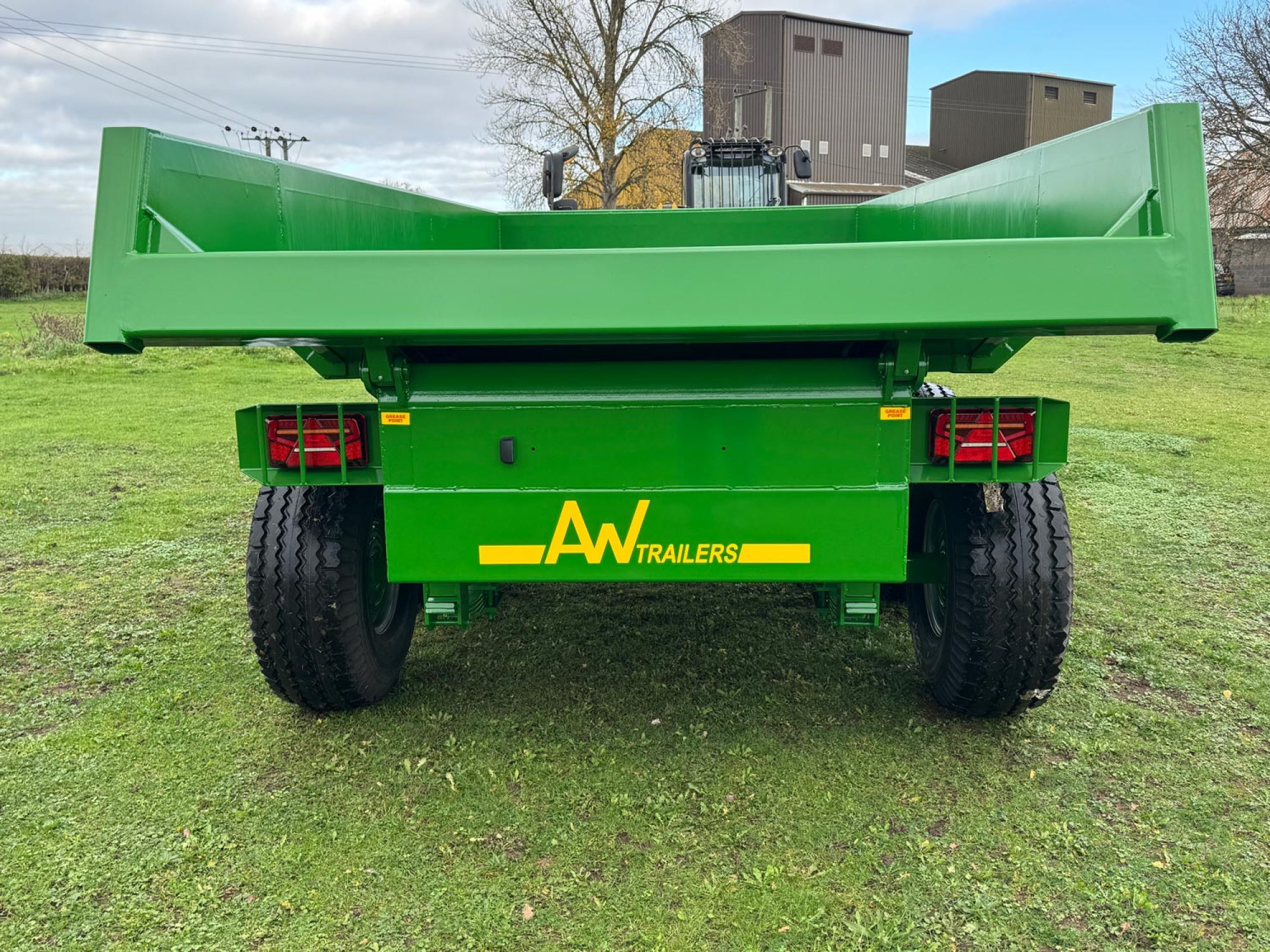 Large green trailer in a field