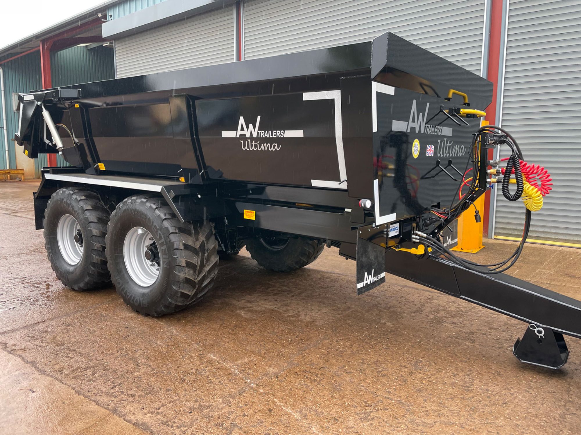 Side profile of a black trailer in a car park