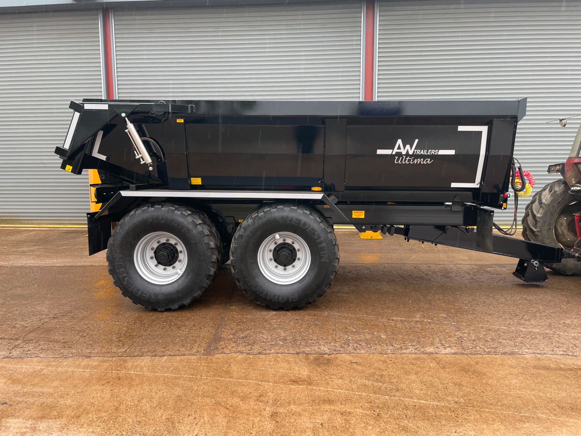 Side profile of a black trailer in a car park