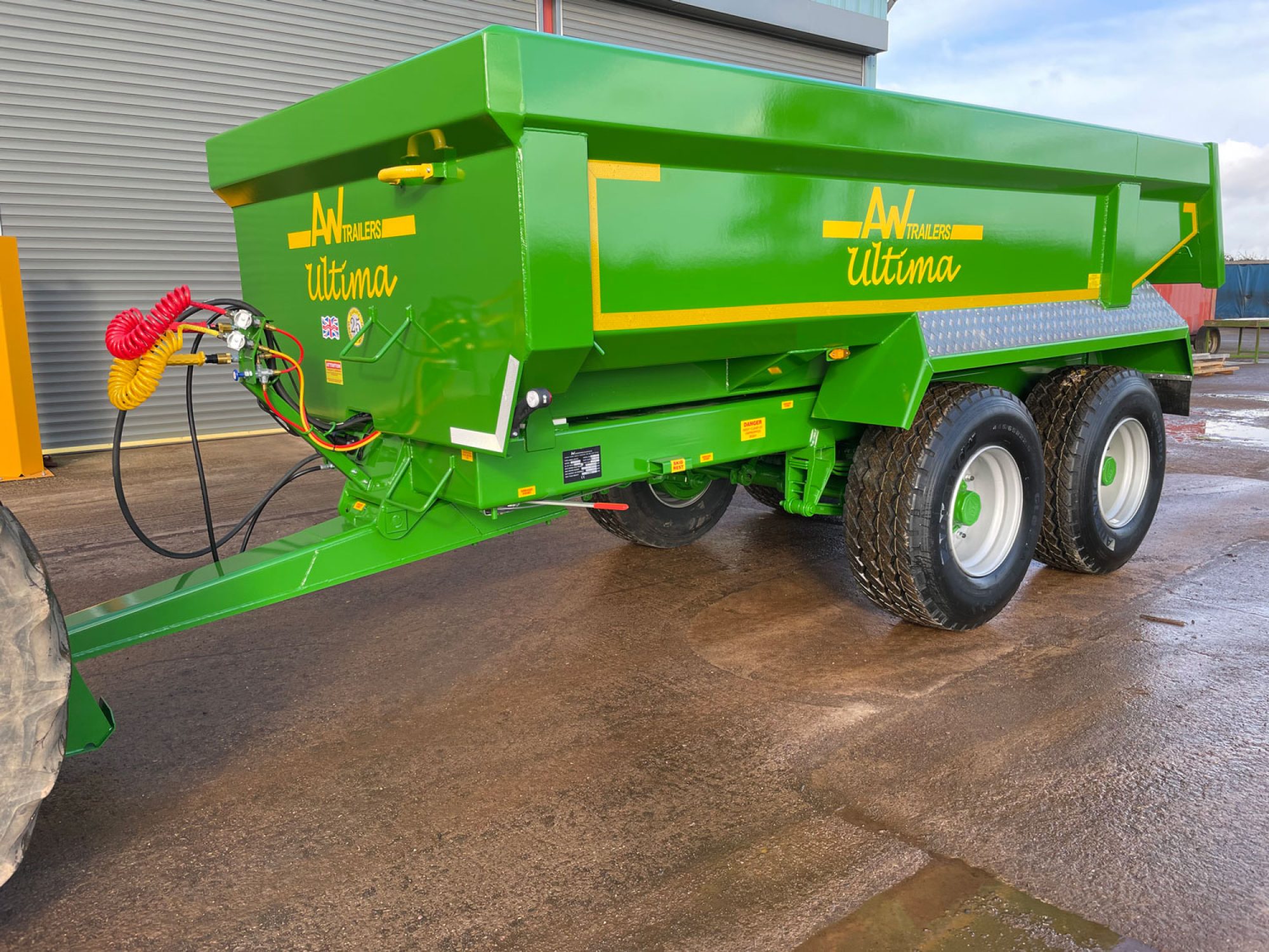 Side profile of a green trailer in a car park