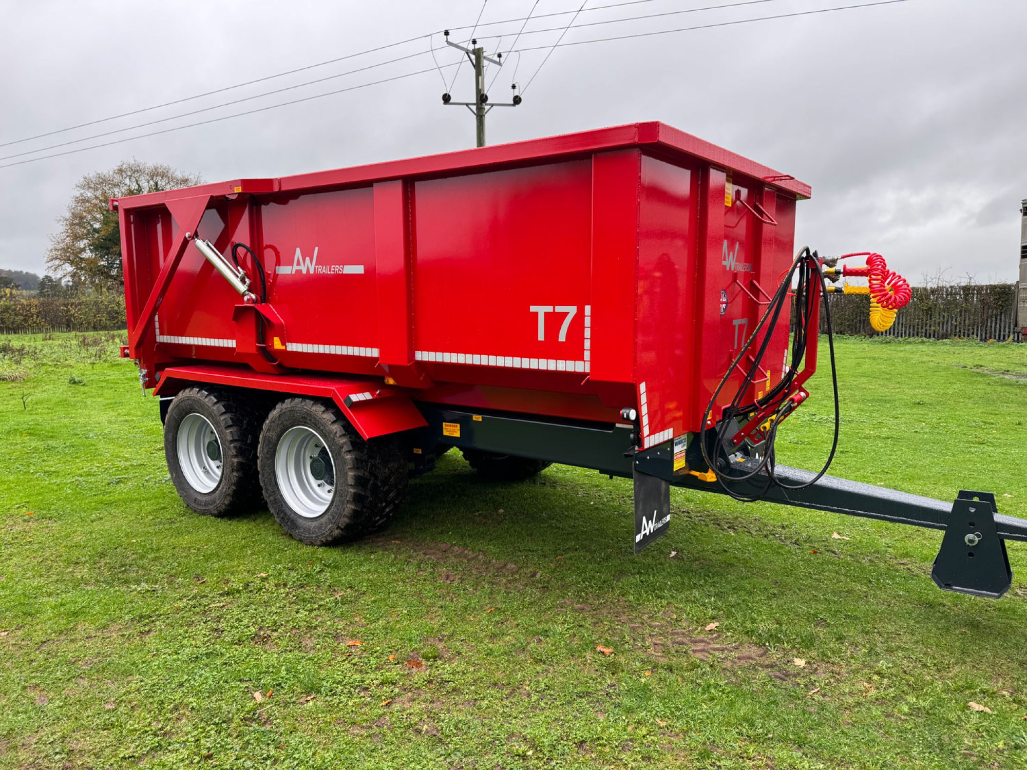 Red trailer in a grass field