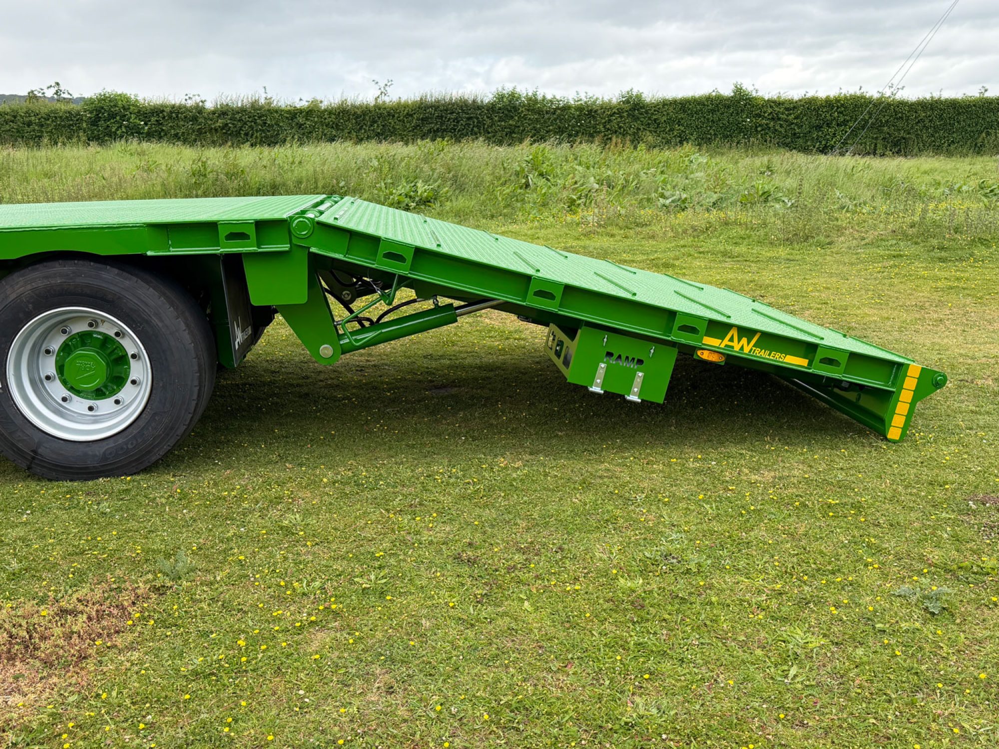 Plant Lowloader trailer in green in a car park
