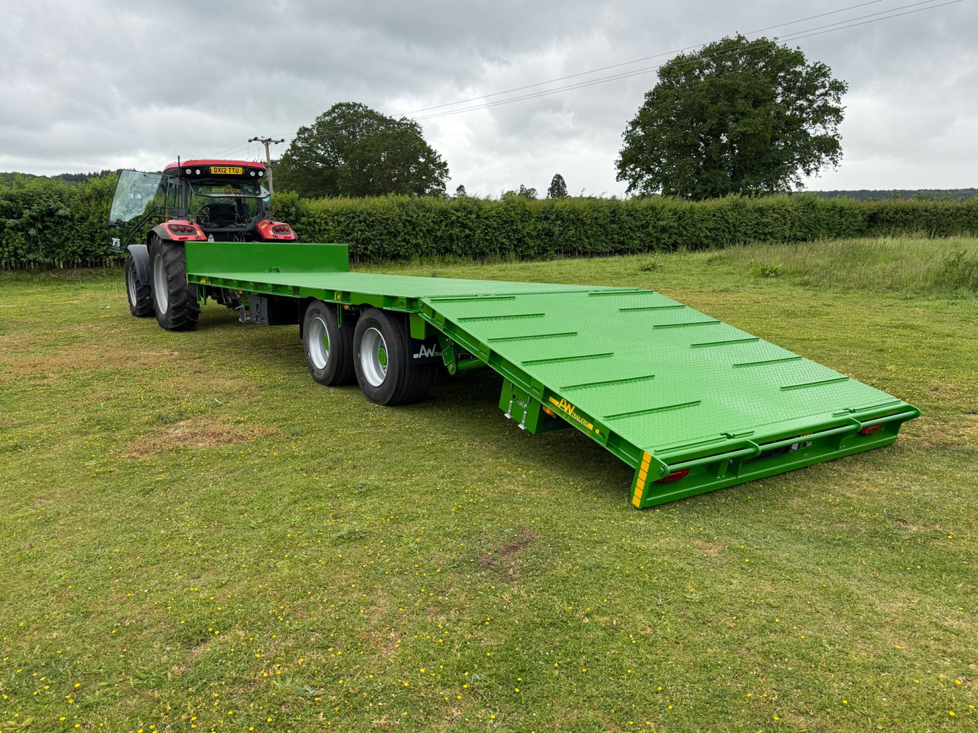 Plant Lowloader trailer in green in a car park