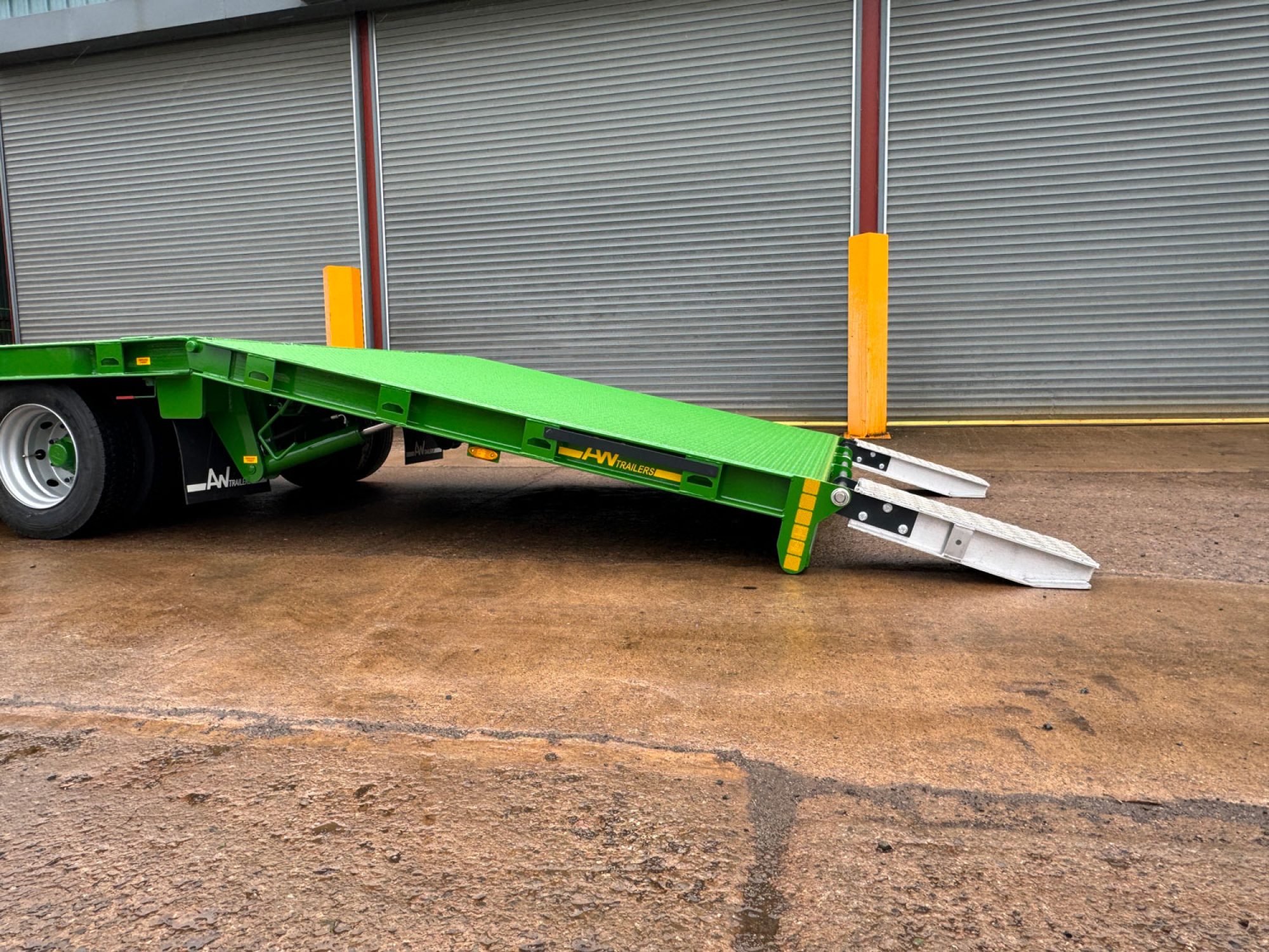 Plant Lowloader trailer in green in a car park