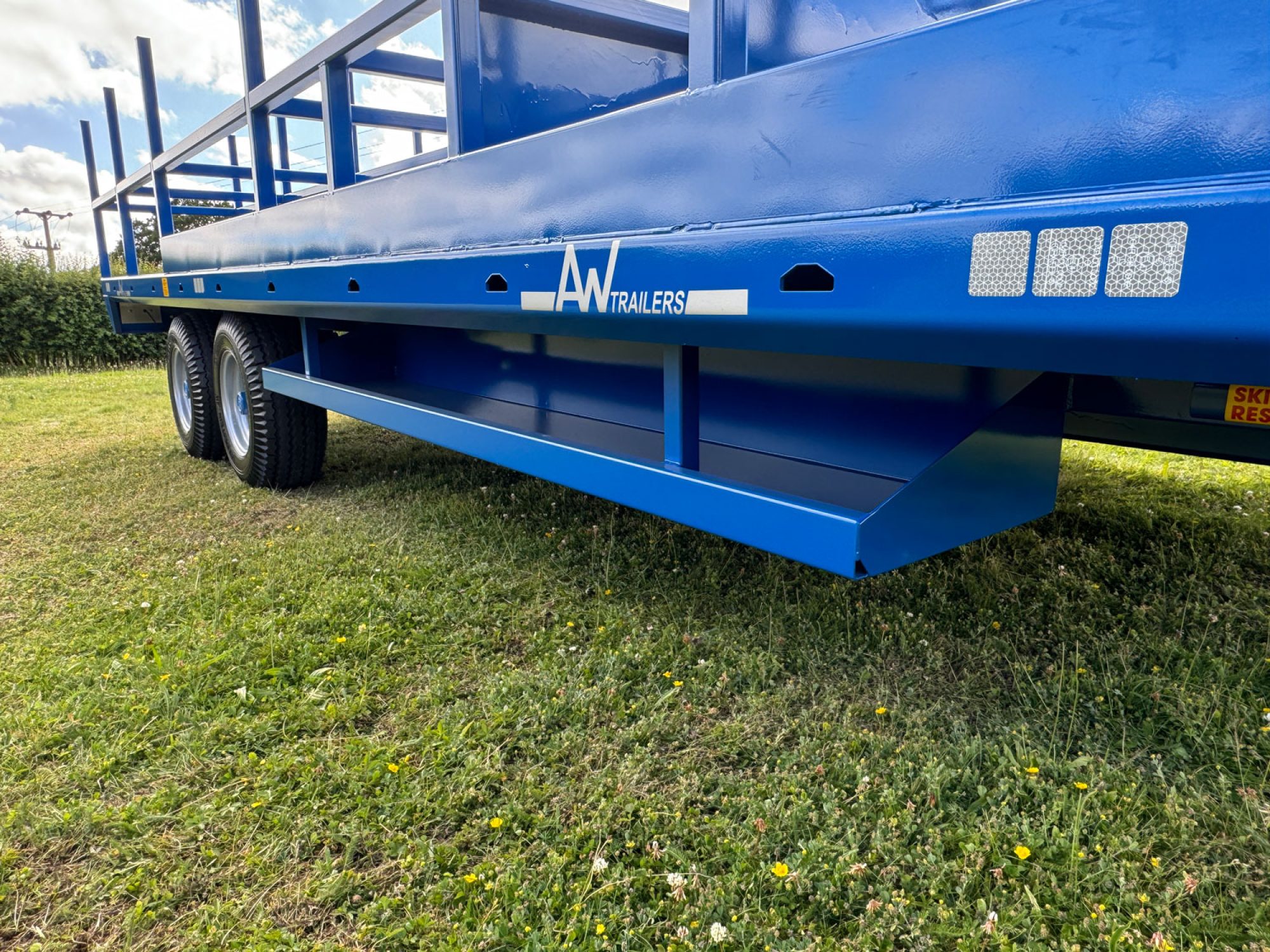 Blue scaffold trailer in a field