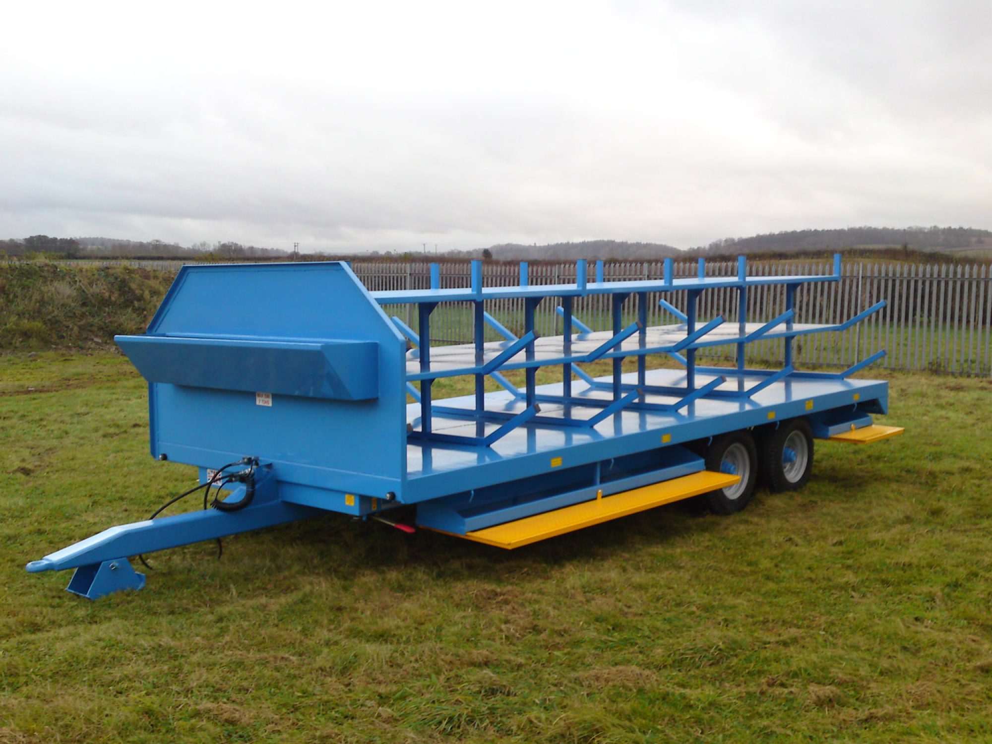 Blue scaffold trailer in a field