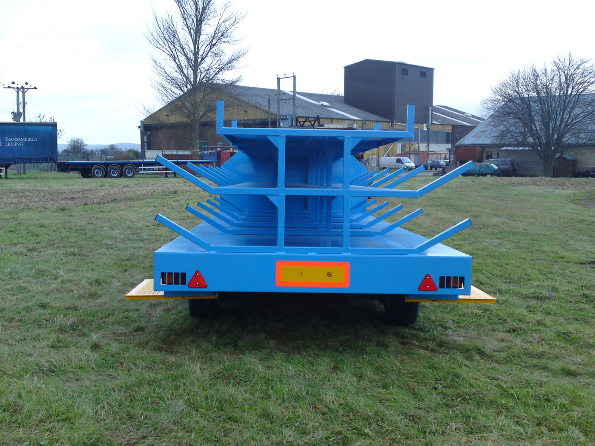 Blue scaffold trailer in a field