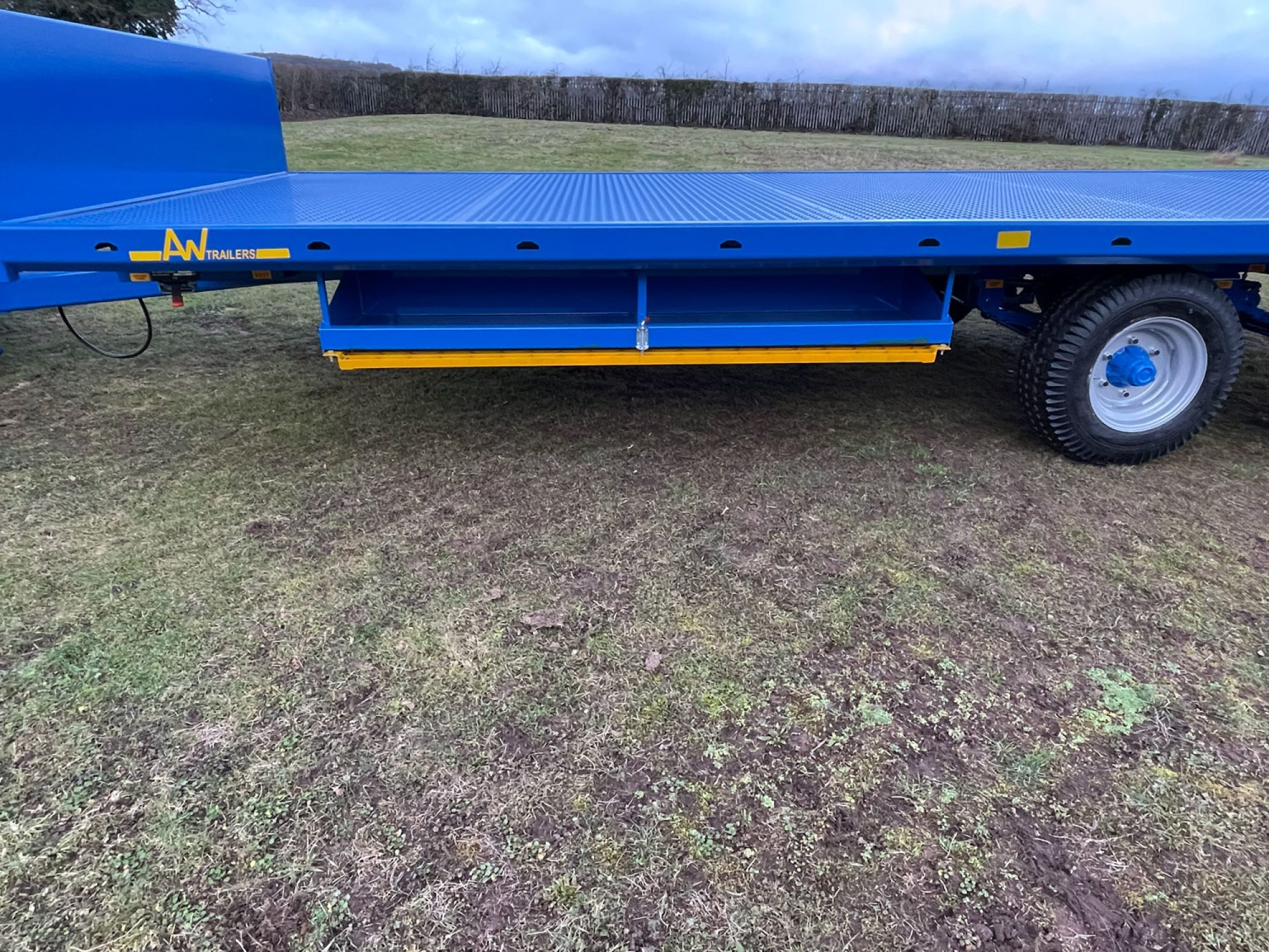 Blue scaffold trailer in a field