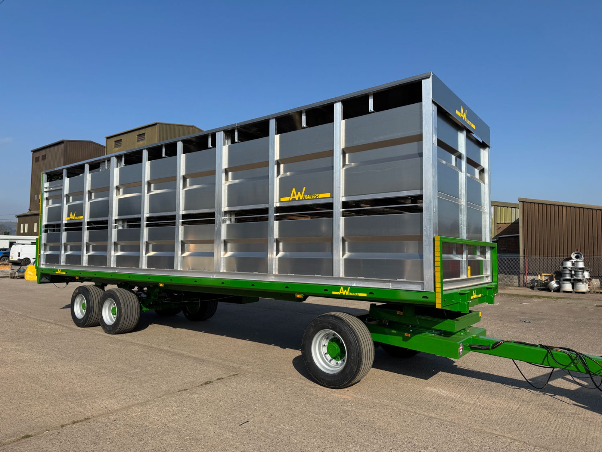 A Large silver stock container in a factory carpark