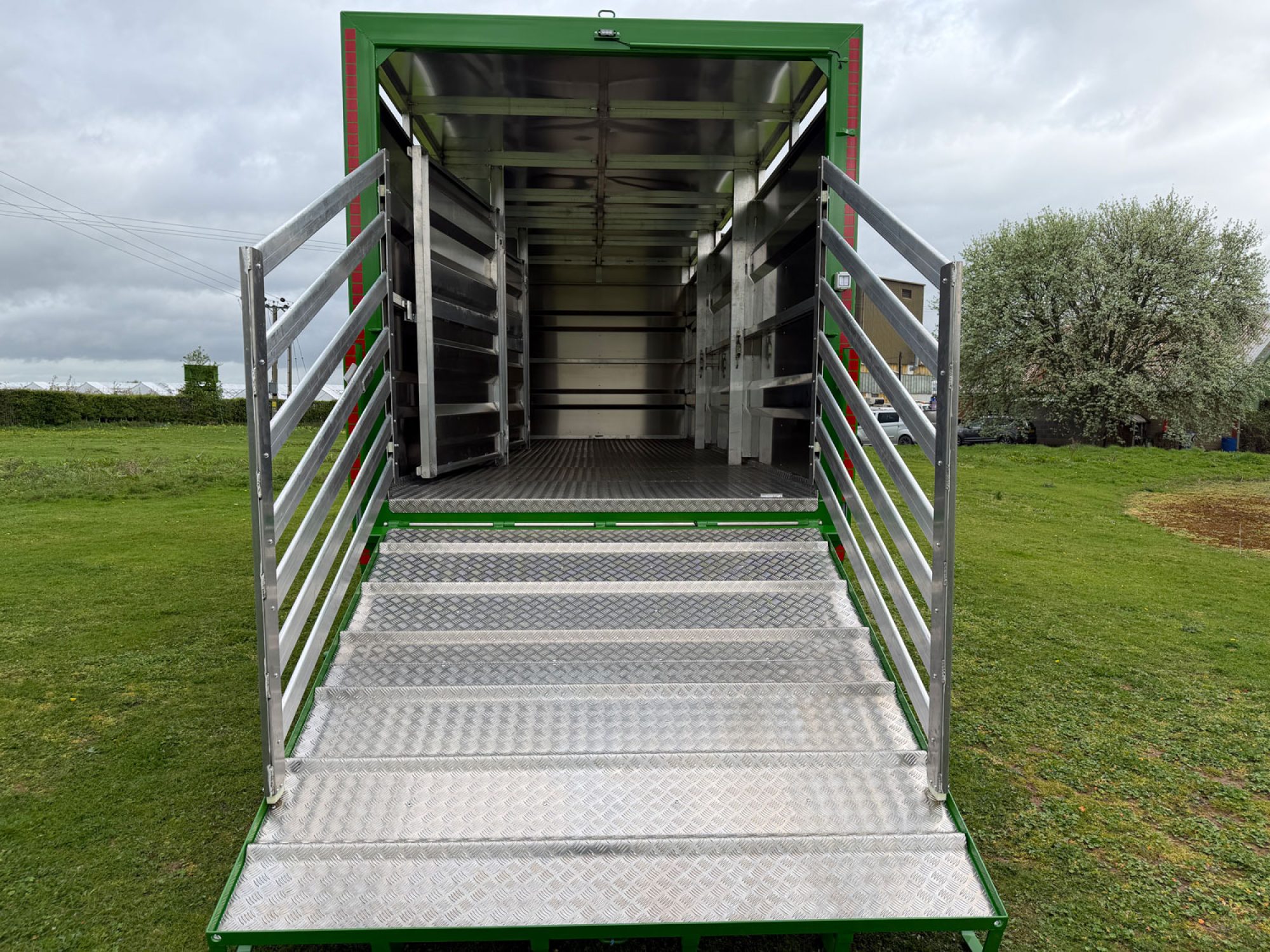 A Large silver stock container in a field