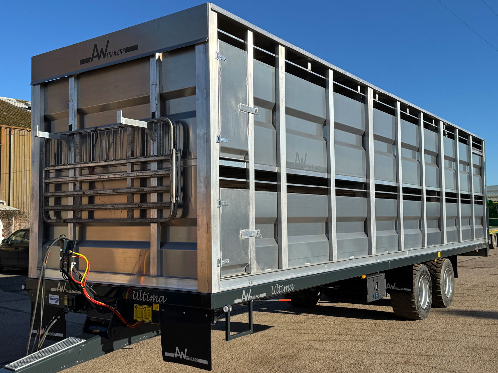A Large silver stock container in a factory carpark