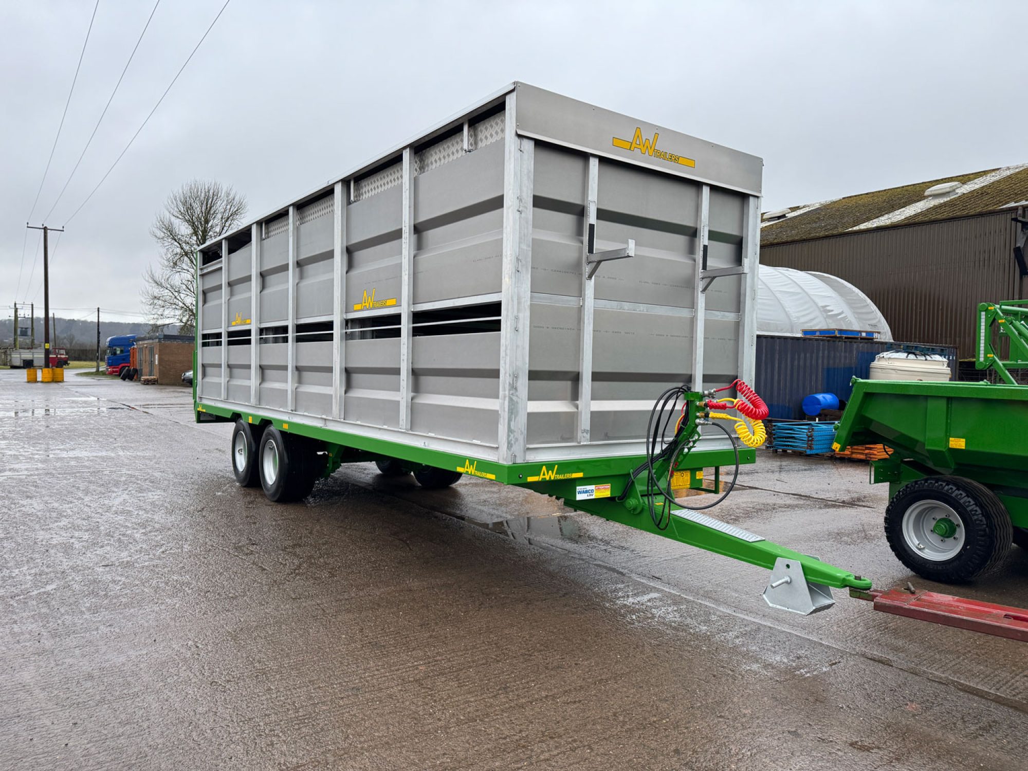 A Large silver stock container in a factory carpark