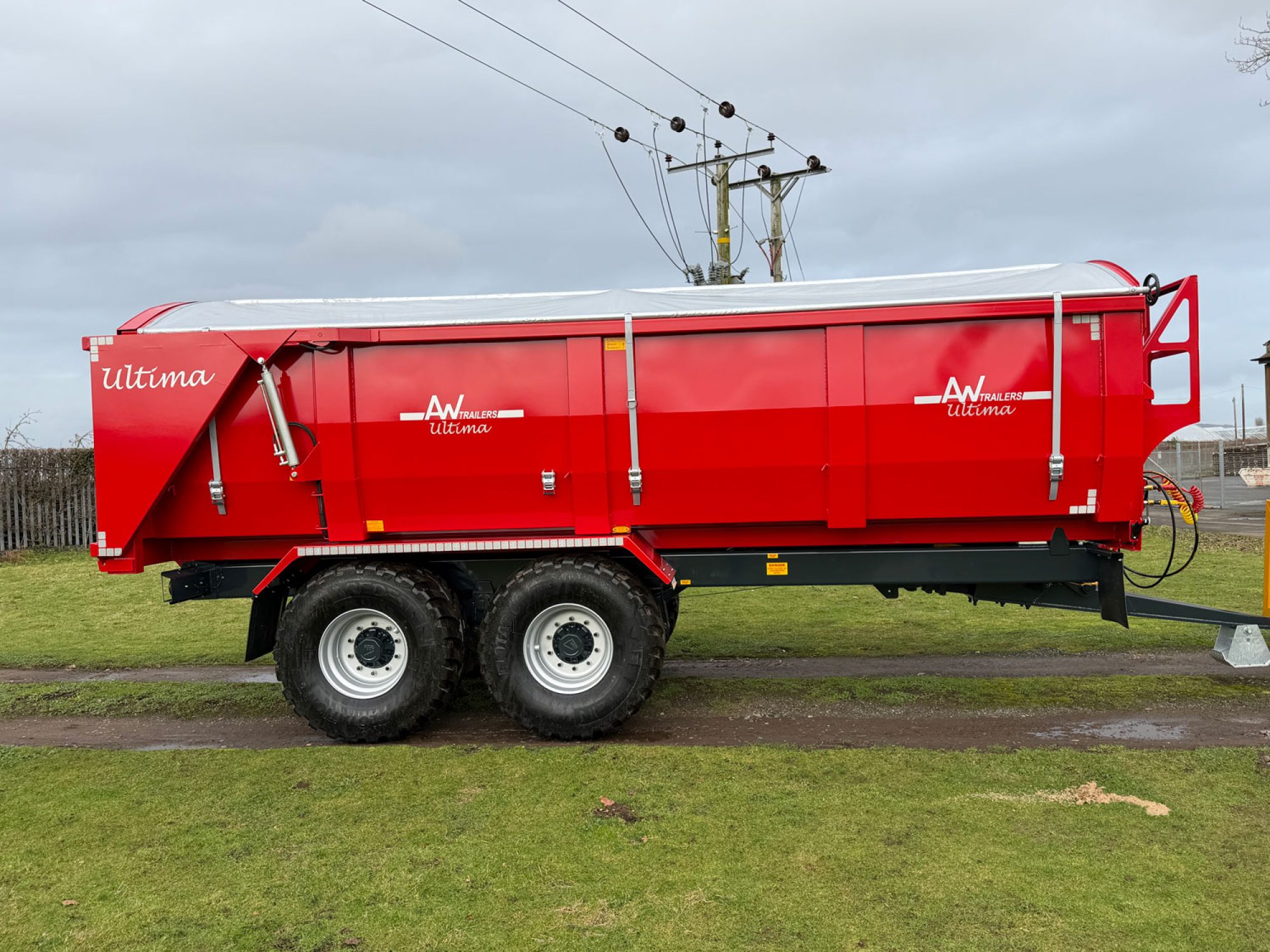 Large red trailer in a grass field