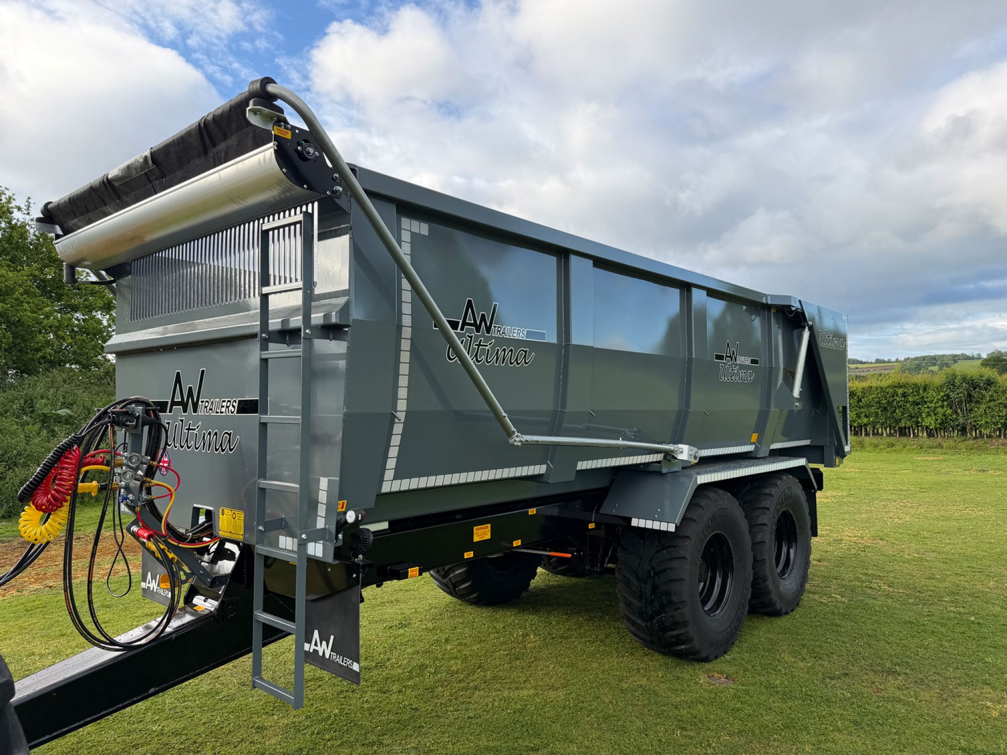 A large grey trailer in a field