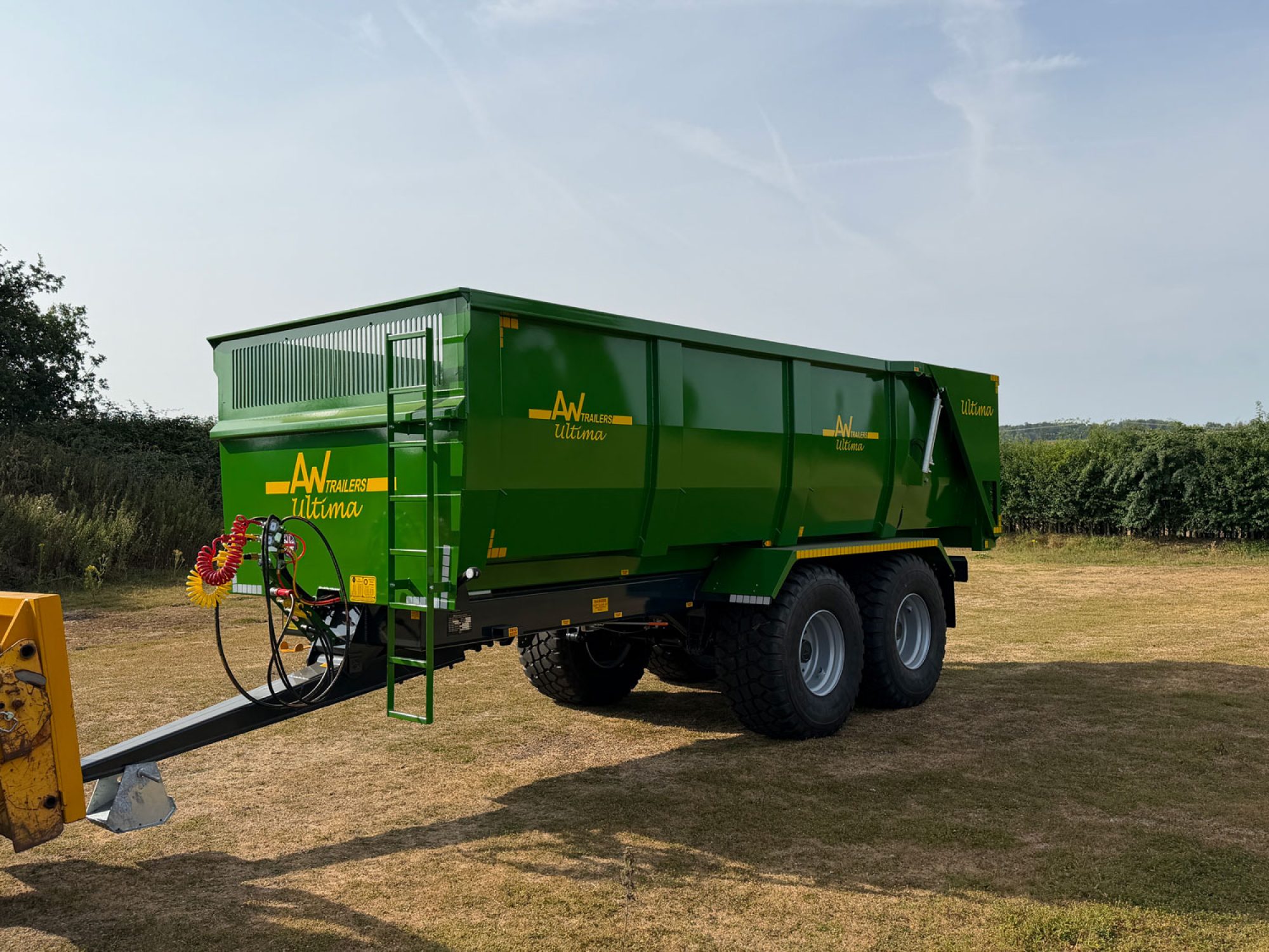 A Large green trailer in a field