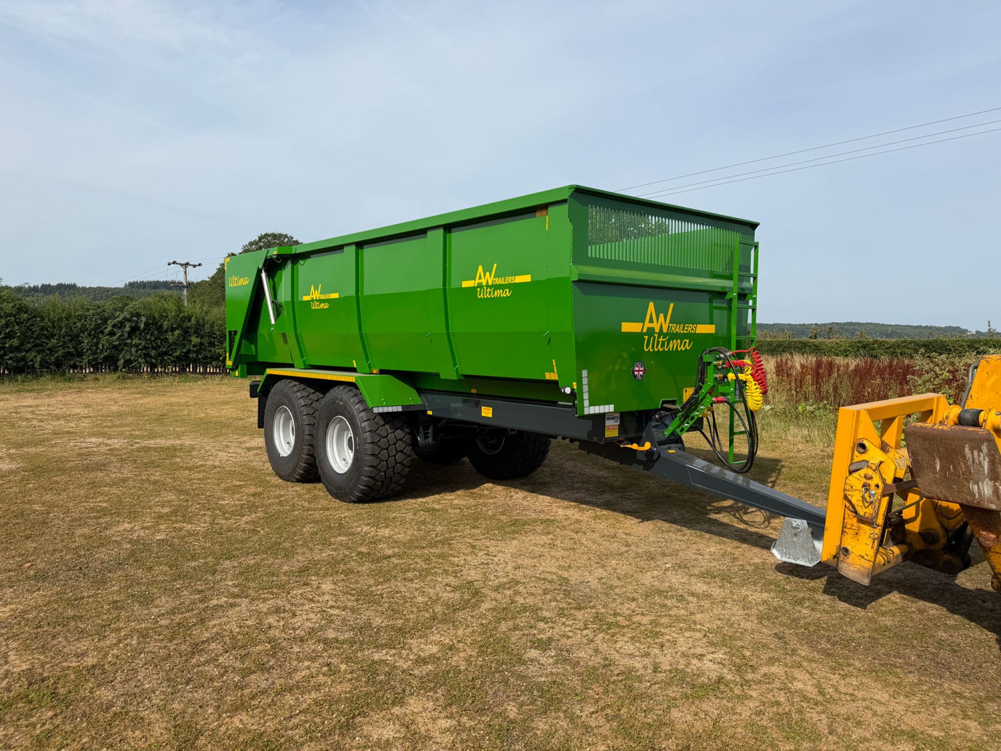 A Large green trailer in a field