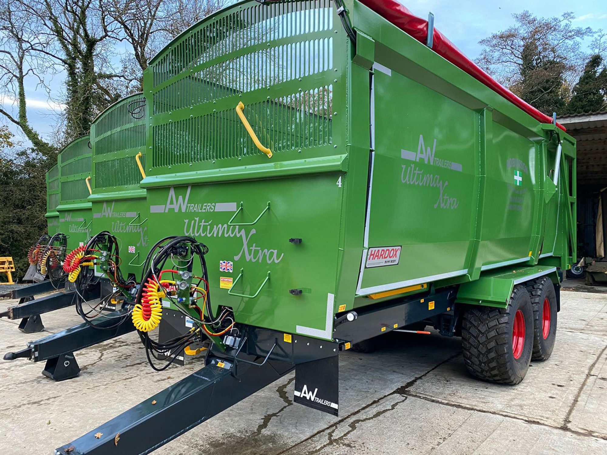 A large green ultima monocoque trailer in a factory carpark