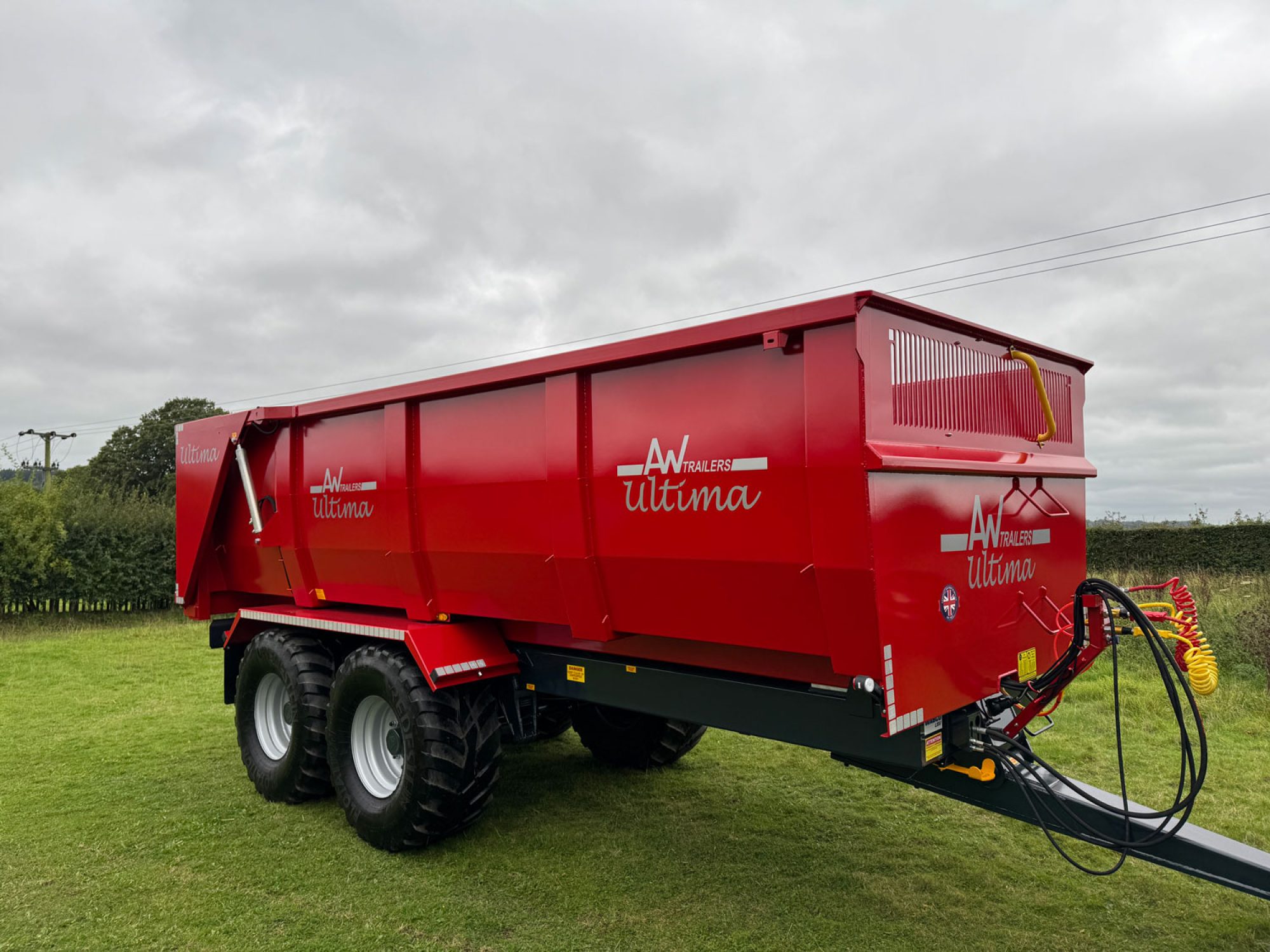 a large red ultima monocoque trailers in a field