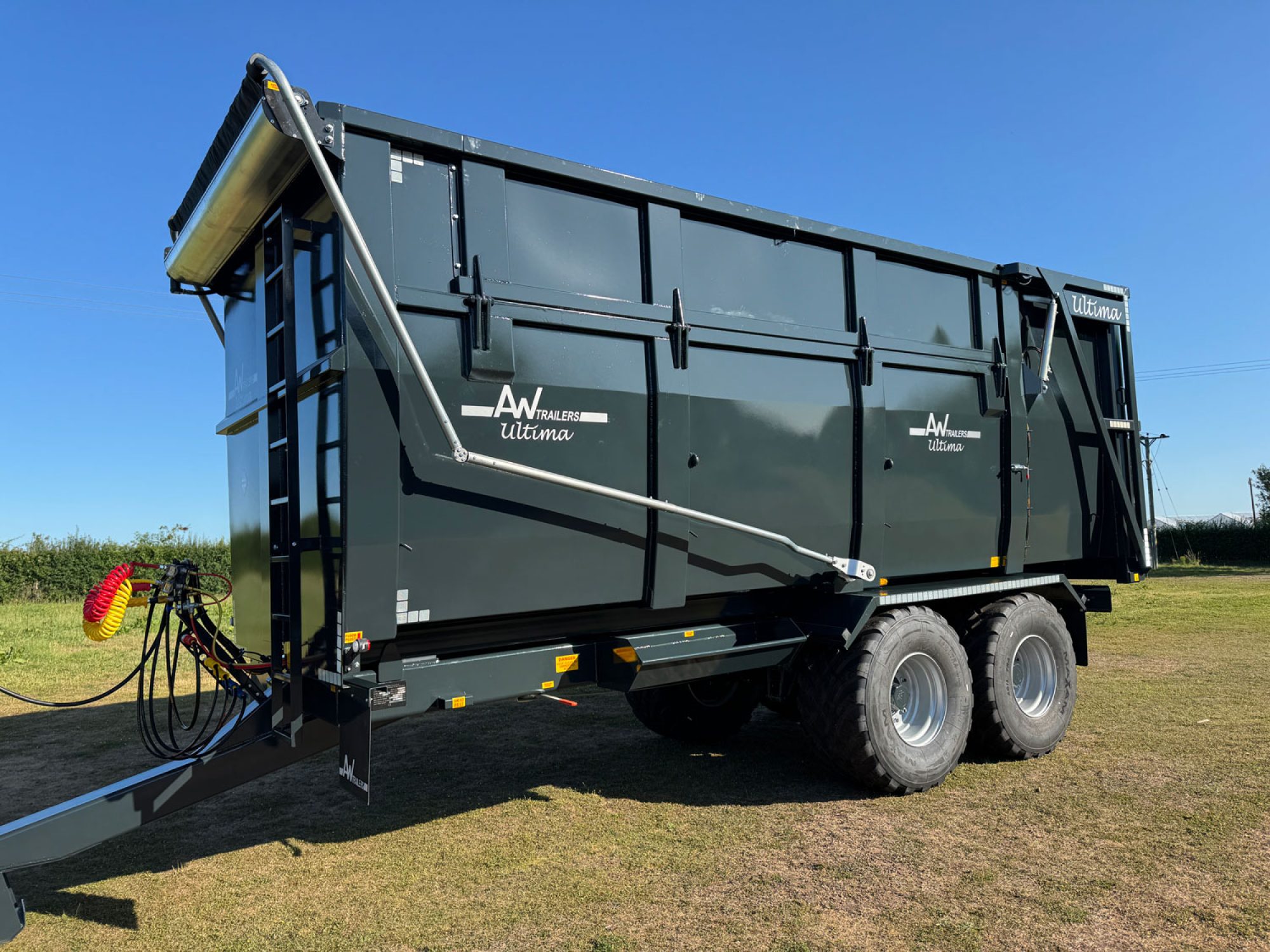 A large grey ultima monocoque trailer in a field