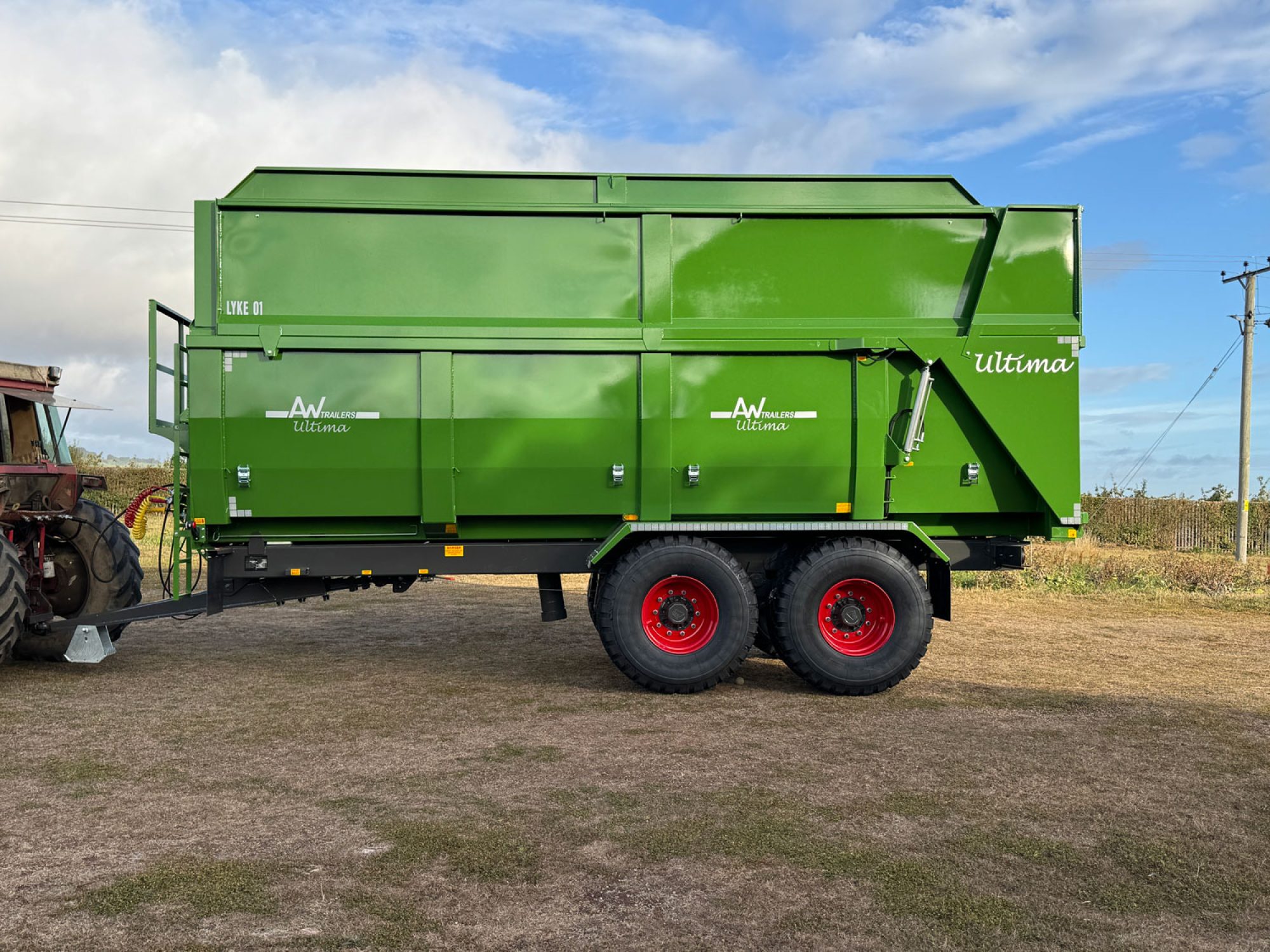 A large green ultima monocoque trailer in a field