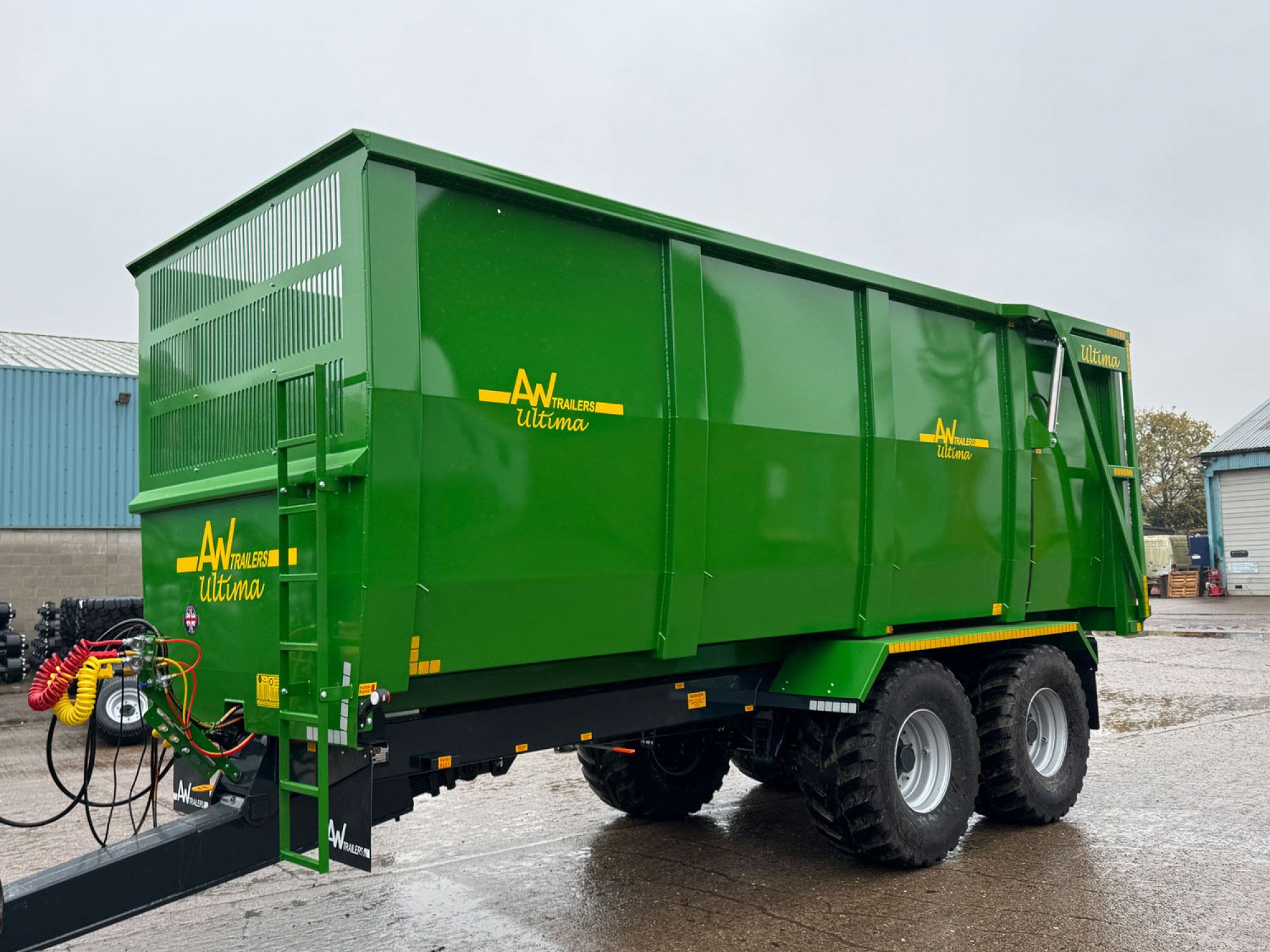 A large green ultima monocoque trailer in a factory carpark