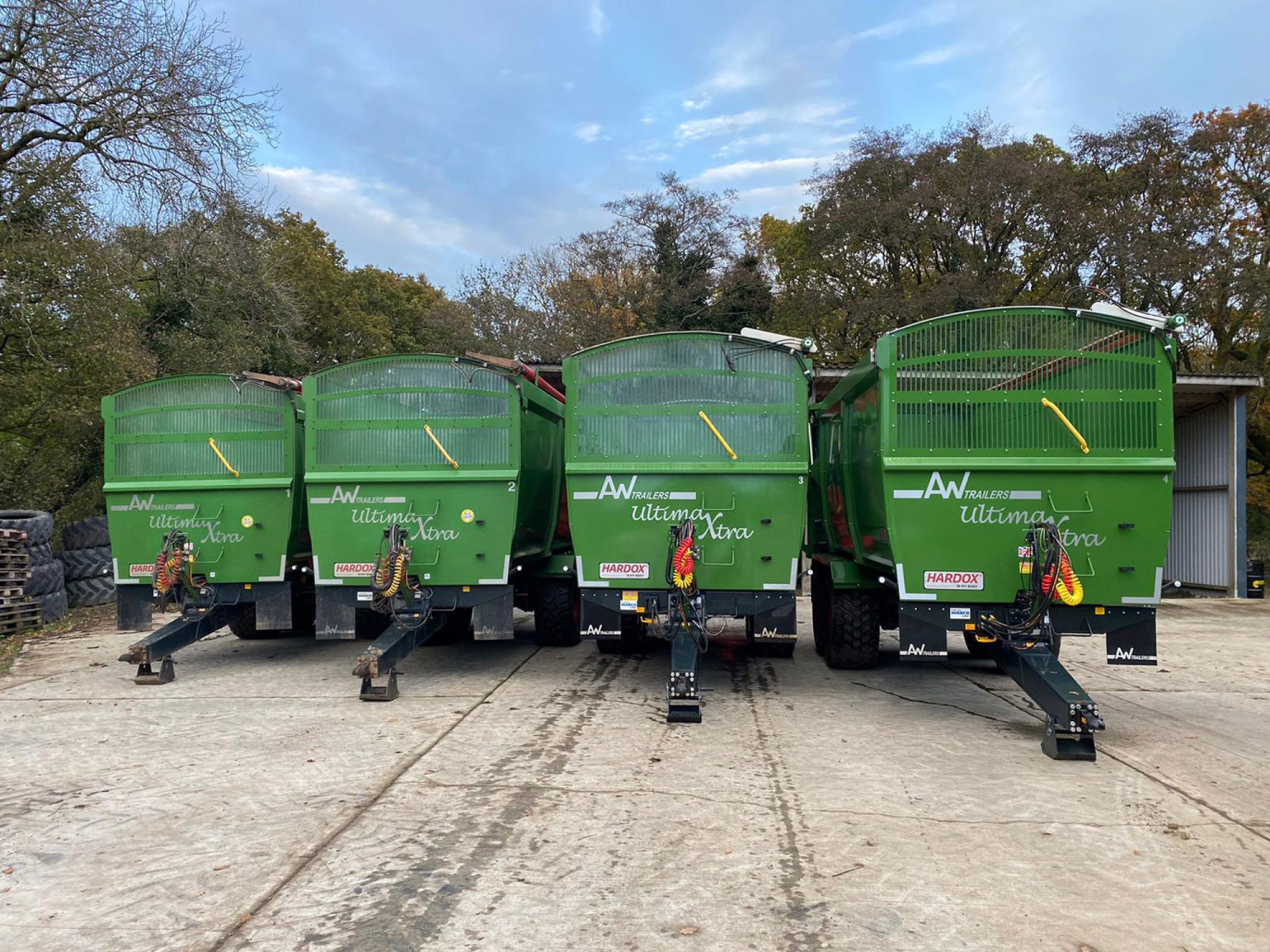 4 large green ultima monocoque trailers in a factory carpark