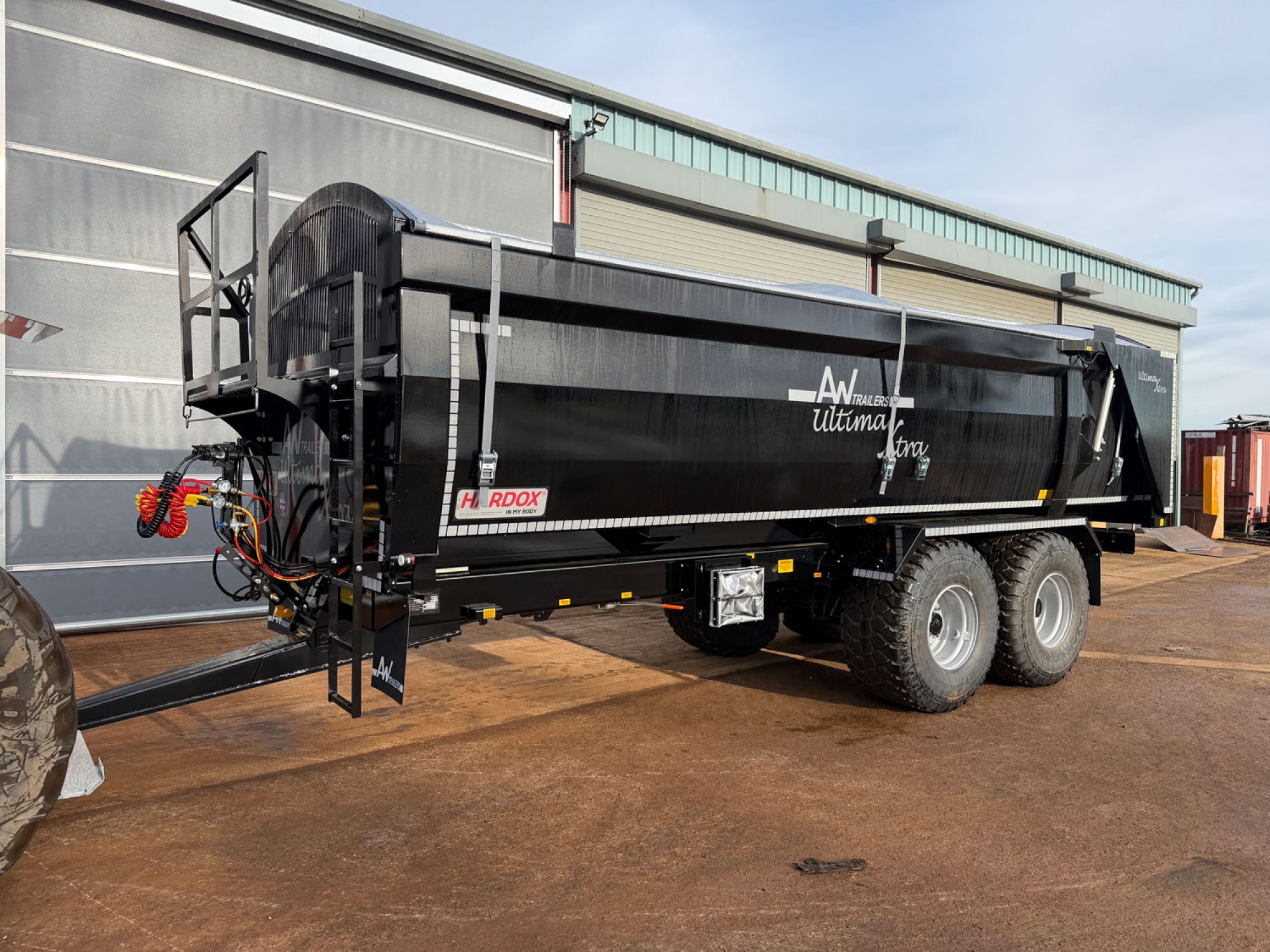 A large black ultima monocoque trailer in a factory carpark