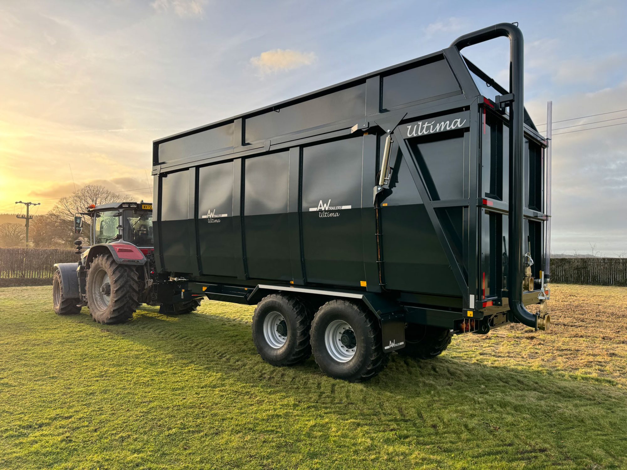 A large black ultima monocoque trailer in a field