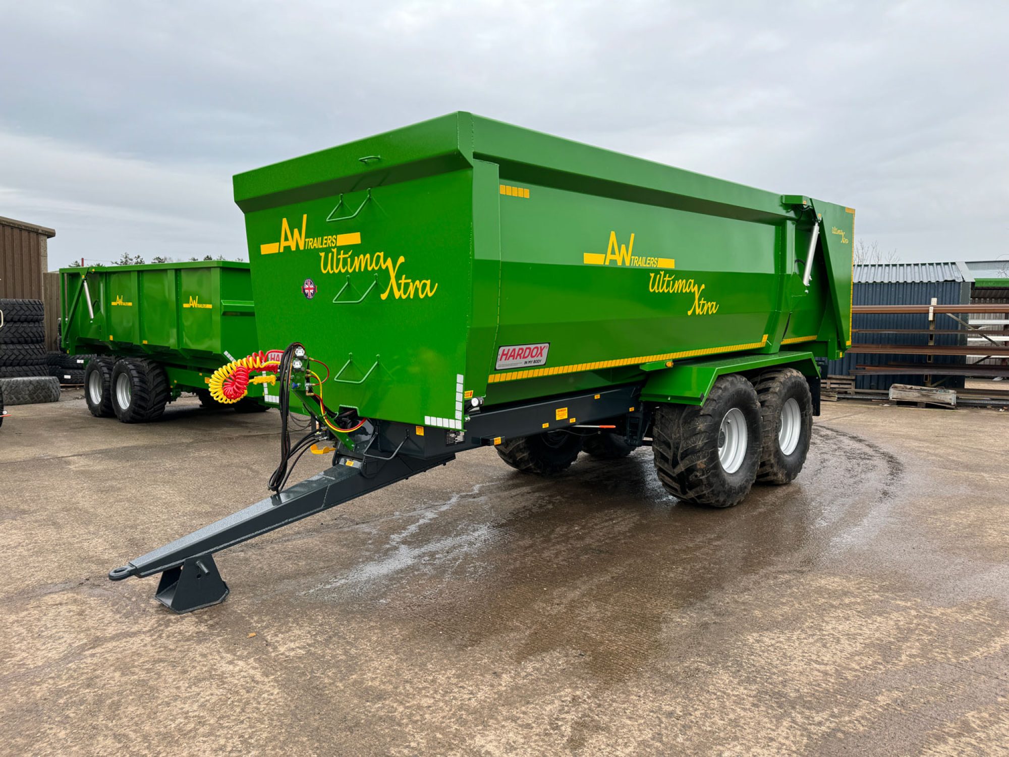 A large green ultima monocoque trailer in a factory carpark